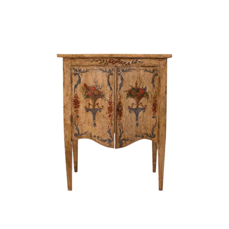 Italian neoclassical cabinet in original pale celadon paint with serpentine front standing of square tapered legs. Decorated in contrasting greens blues and coral depicting floral themes popular when the piece was made.
Good where ever you need a