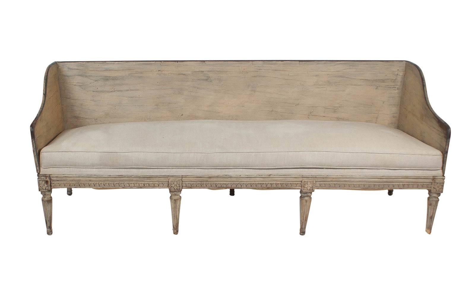 A Swedish Gustavian painted sofa, circa 1780, in worn gray blue paint that appears to be original. This design is a rarely seen and this sofa is actually comfortable. This piece was collected in Europe approximately 20 years ago. The upholstery was