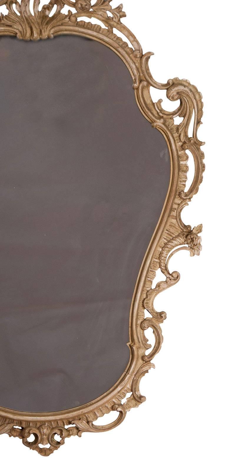 A large and decorative hand-carved and painted wood vintage mirror. Although the inspiration for this piece comes from the continent it was made in England, circa 1920. This eccentric Baroque style was seen in England about 1750 and reflected in the