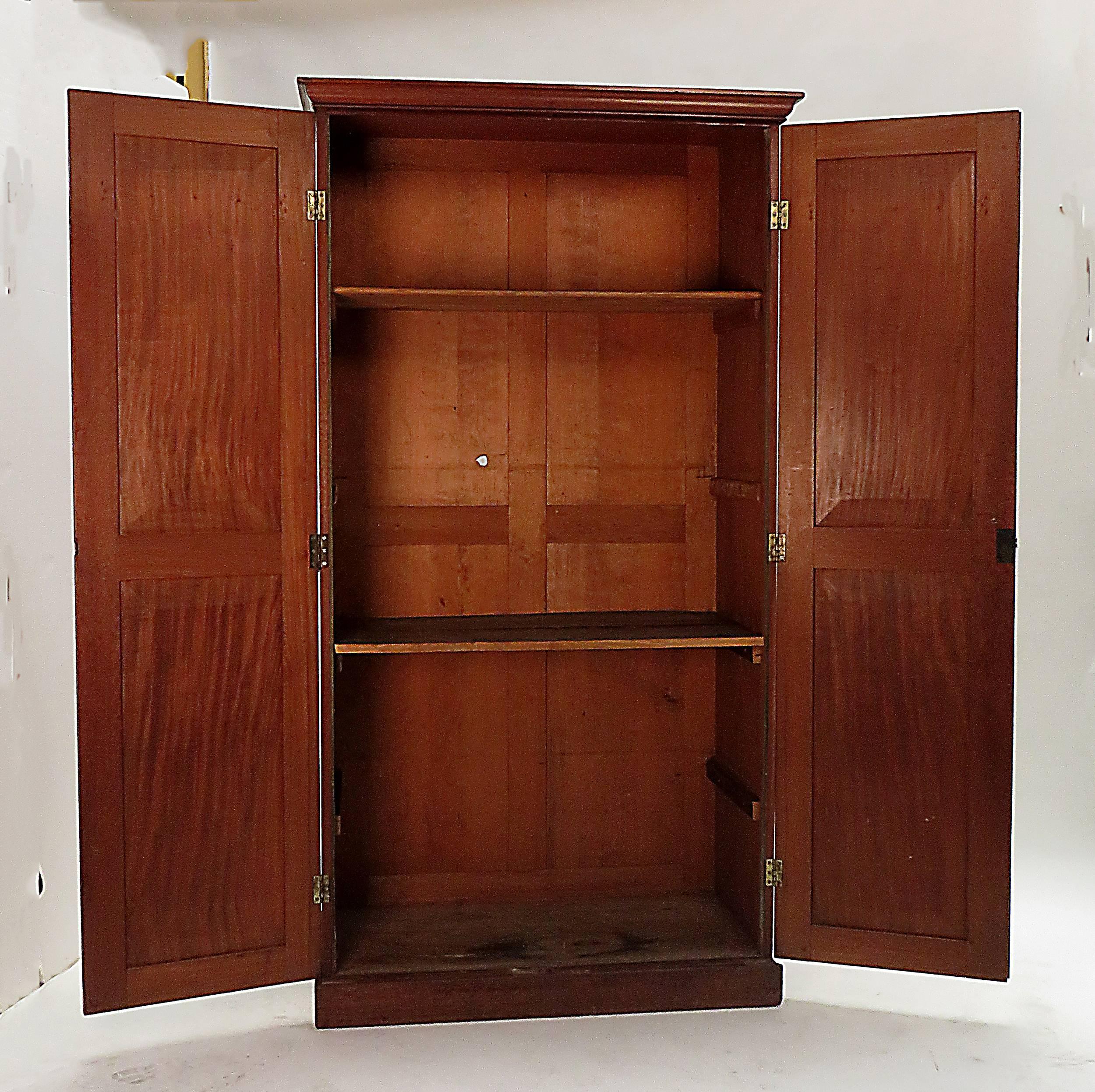 A handsome and useful English mahogany cabinet or book case made during the first part of the Victorian period, about 1840.   Pieces this size are fairly scarce and the simplicity of design along with the quality of the wood make this a particularly