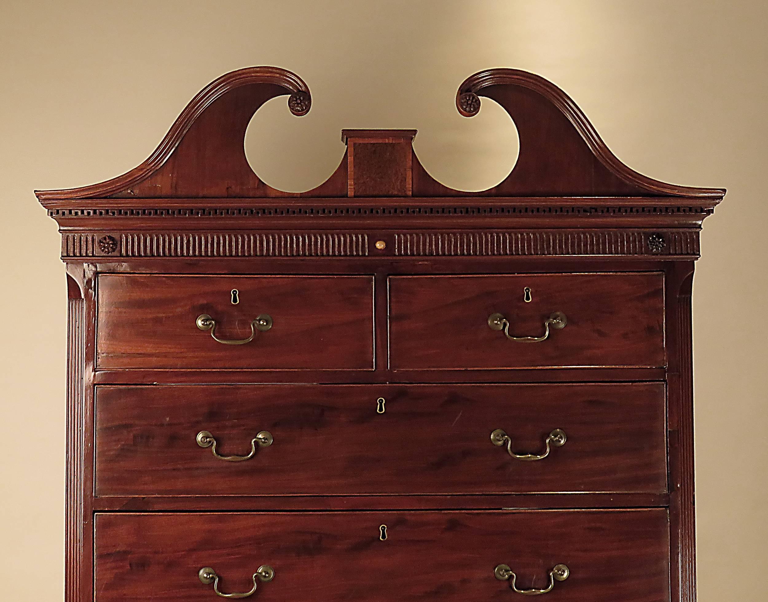 A good example of a George III period mahogany chest on chest. Standing on bracket feet with what appears to be original brass swans neck handles. A useful brushing slide over three graduated drawers. The top section features nicely carved quarter