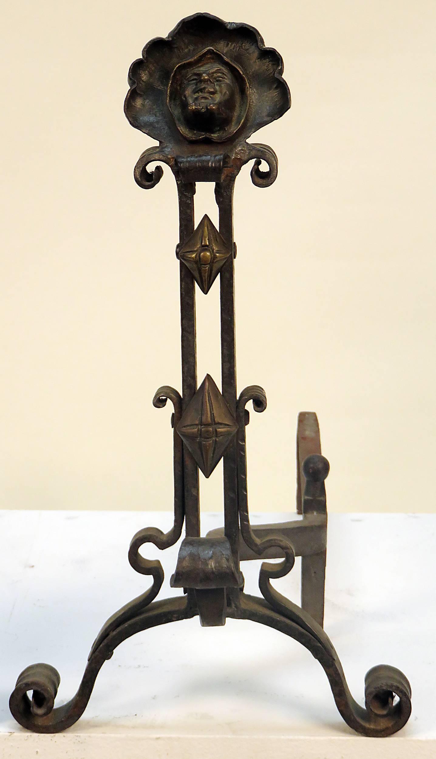 A pair of American Gothic Revival andirons in wrought iron and bronze. The andirons have a the faces of monks surrounded by their cowls. Very high quality casting and hand work in the wrought iron.  We date these to about 1870.