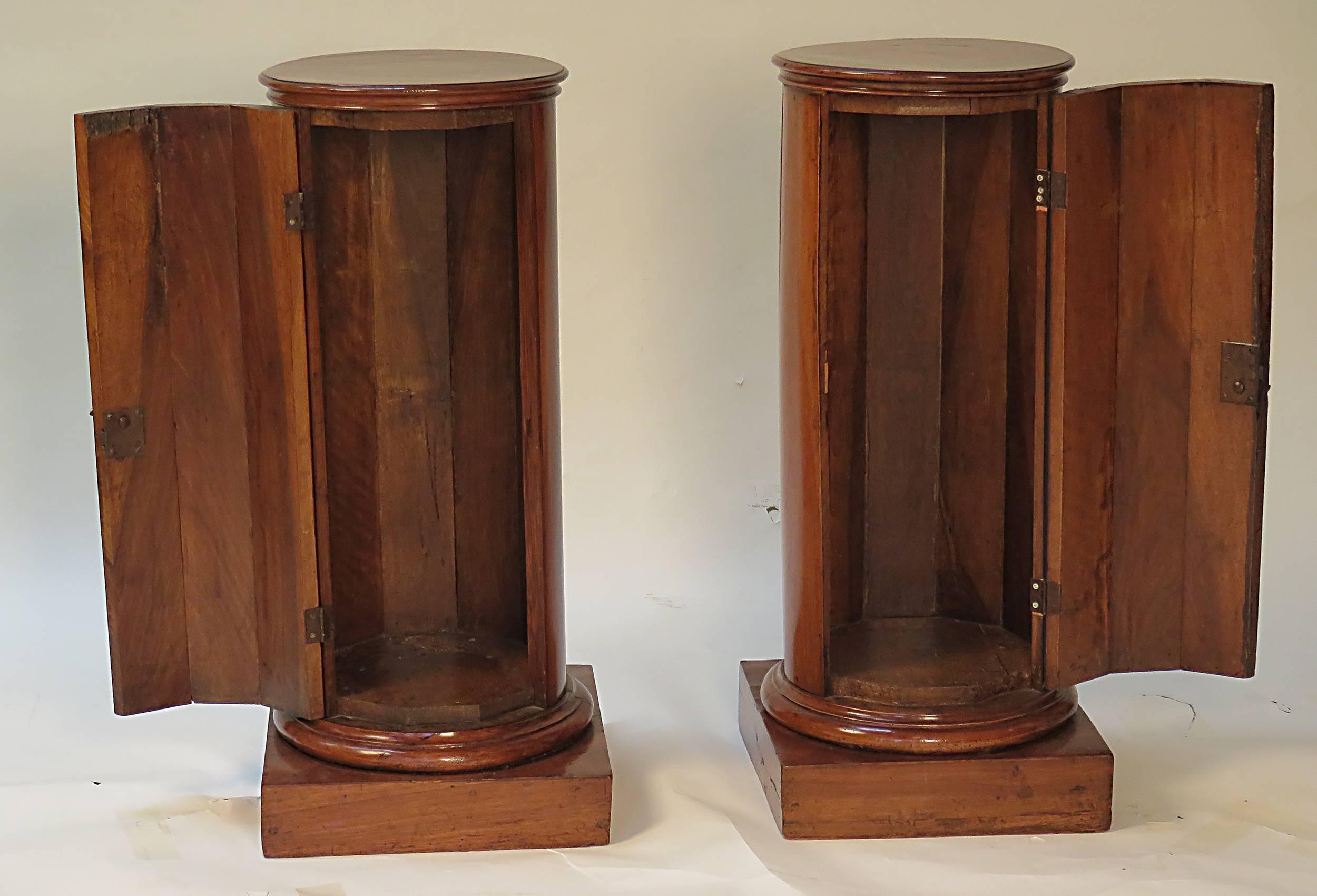 A rare and beautiful pair of 19th Century French Neoclassical fruit wood column cabinets made during the first half of the 19th Century, circa 1830. This wonderful pair would stand nicely on either side of a door or make excellent nightstands where
