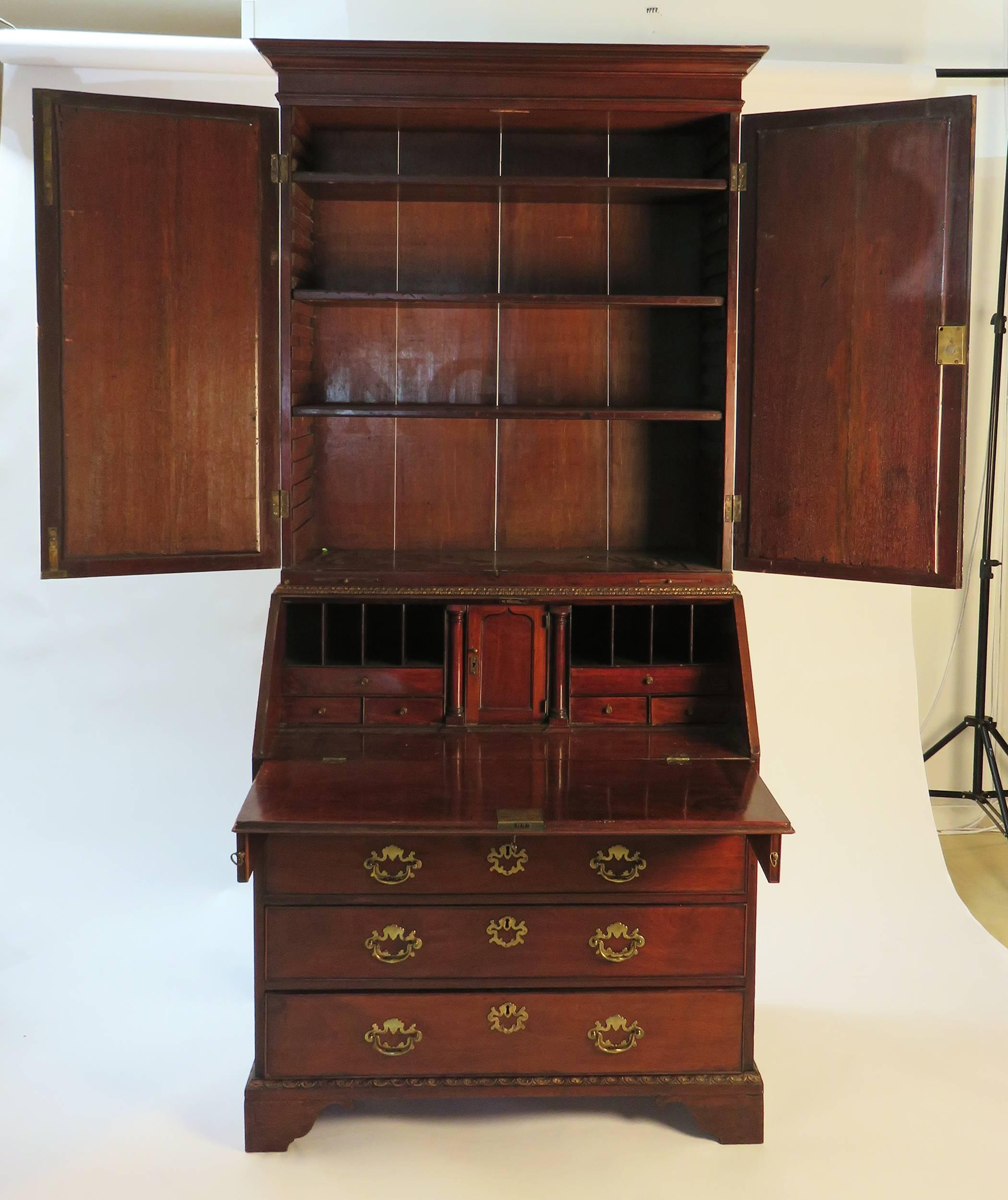 A very nice mahogany gilt slant front secretary bookcase with mirror and gilt accents. This particular design and construction is associated with Giles Grendy. We date this to the third quarter of the 18th century, circa 1770. The smaller scale of