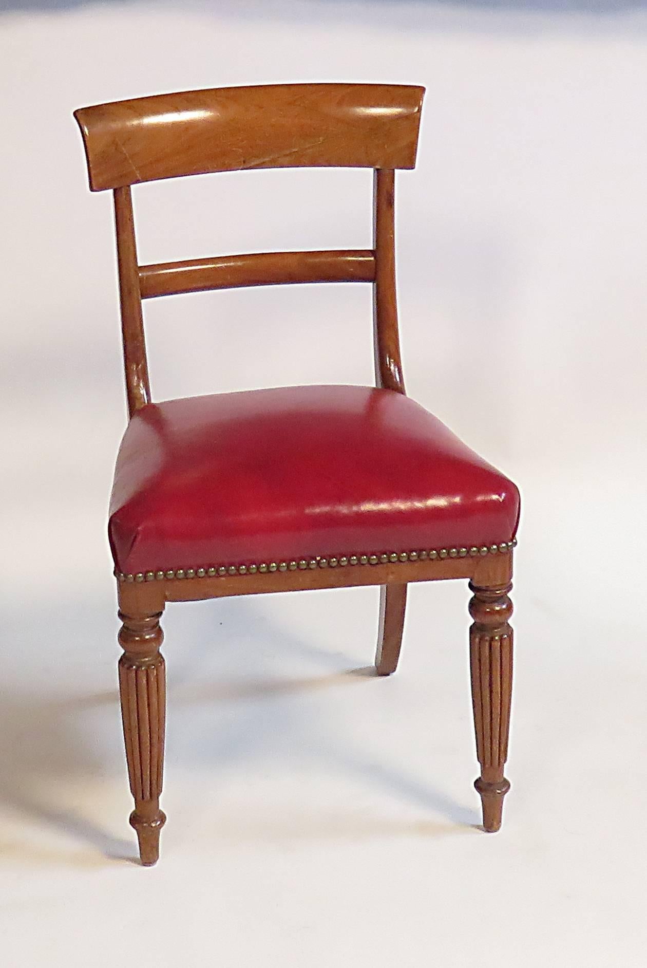 A set of four English mahogany side chairs with later matching red leather seats.  Made in the United Kingdom, circa 1820. 