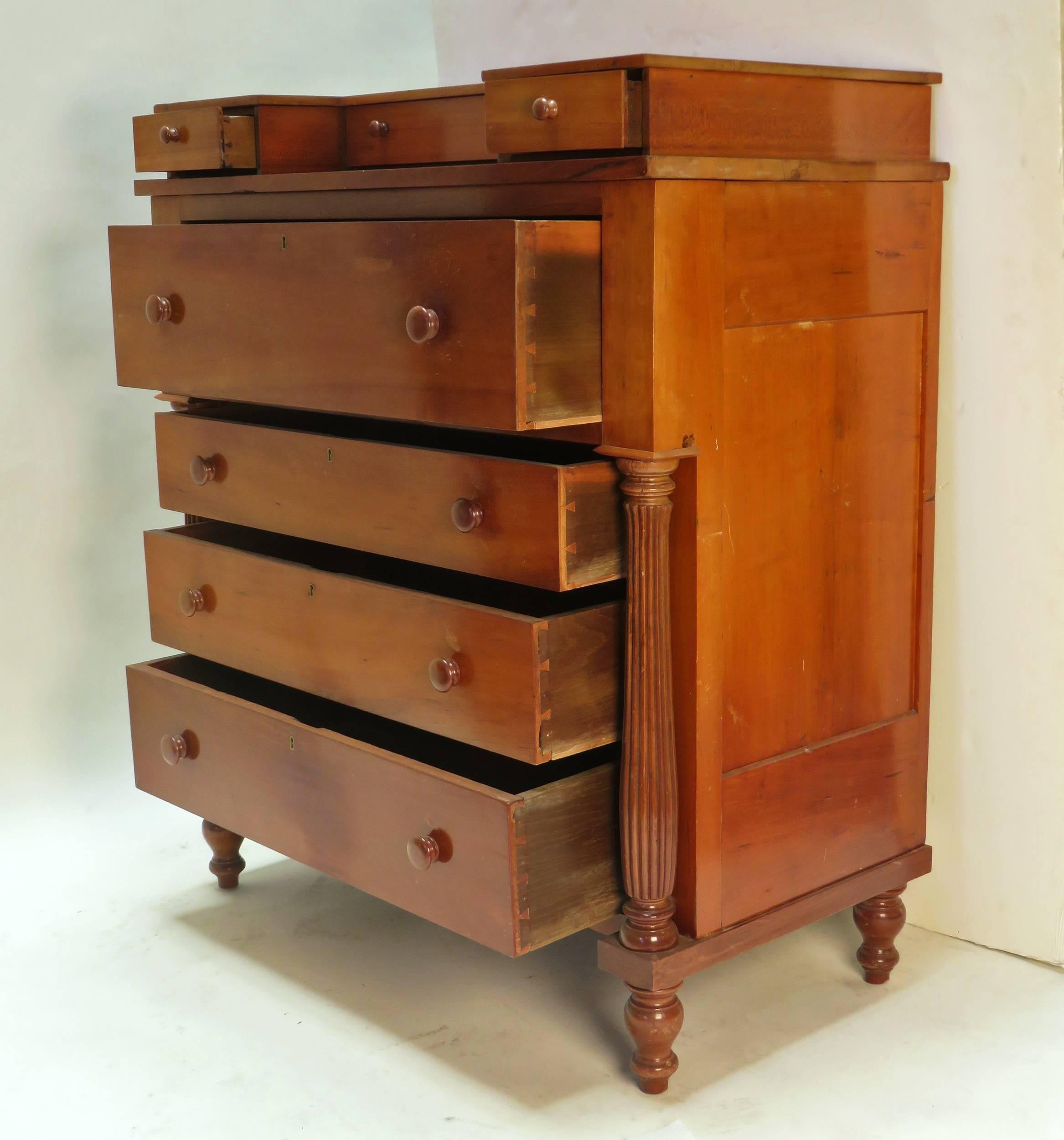 A useful and handsome American chest of drawers, circa 1840 probably in the area around Virginia. Typical turned feet support two fluted shaped columns. The small upper drawers are a nice feature.