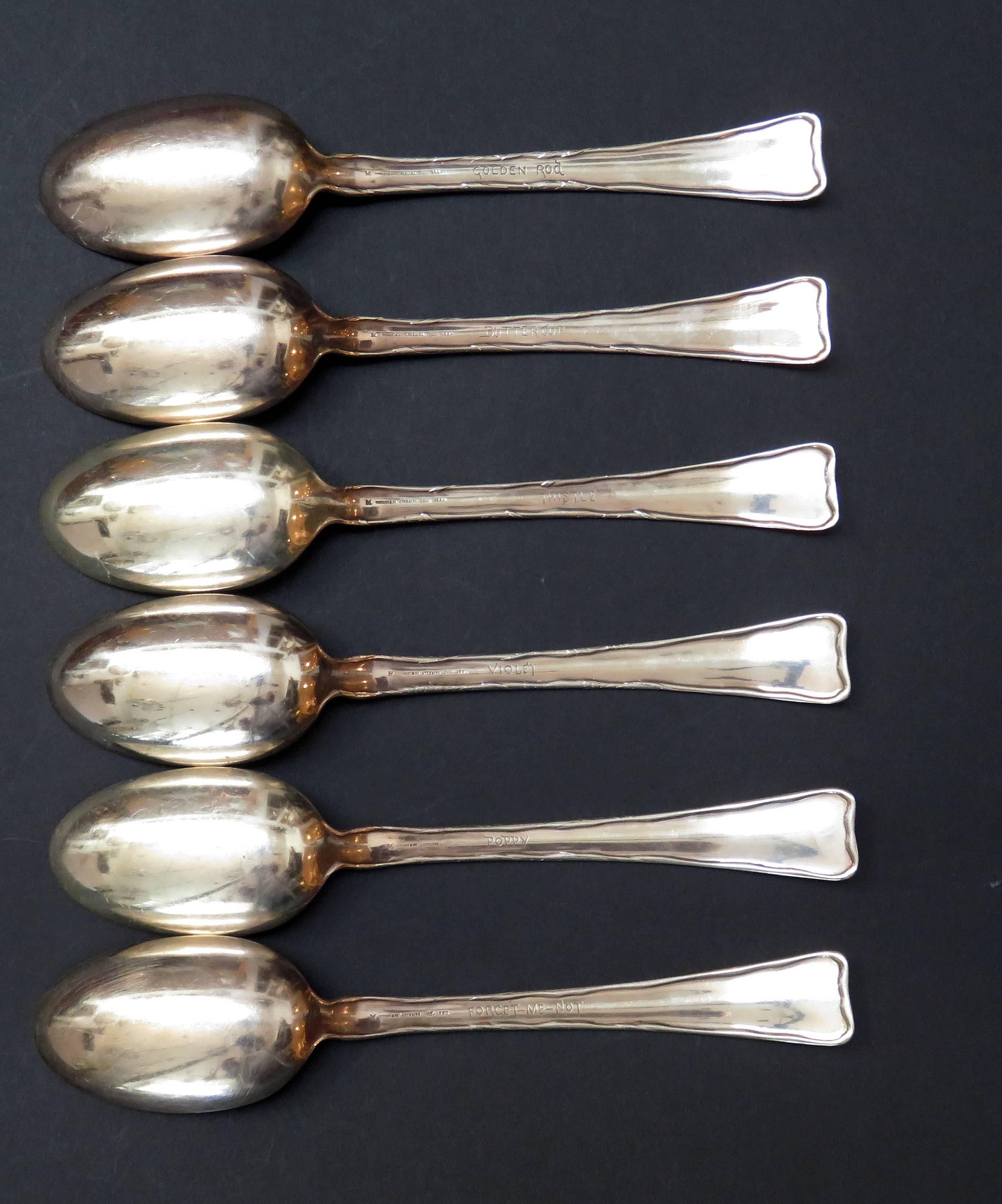 A set of six Tiffany & Co lap over edge acid etched table spoons etched with different flowers. Each spoon has the name of the flower engraved on the reverse. Each spoon is marked Tiffany & Co Sterling Pat 1880 with the date mark of 