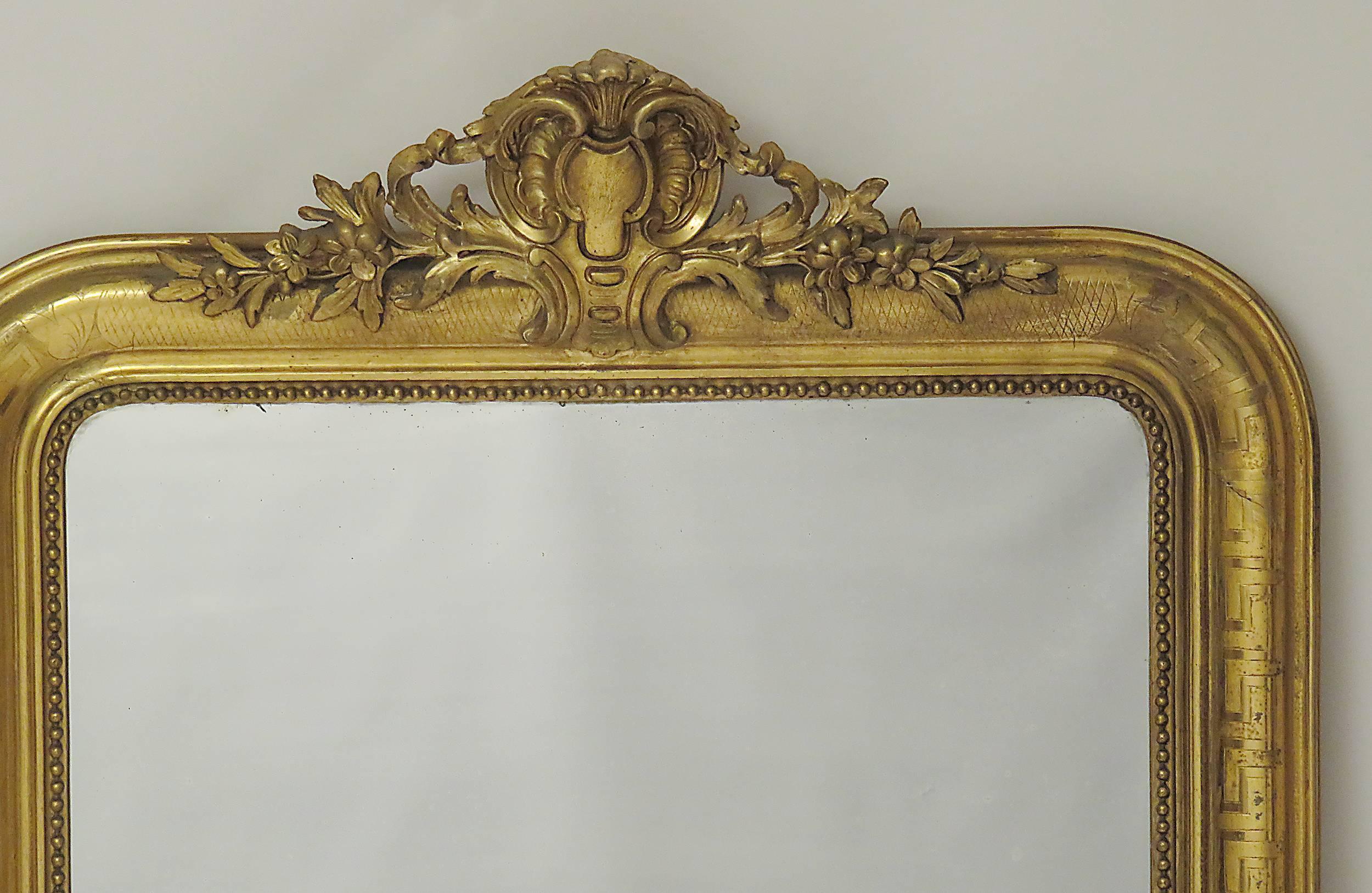 A well proportioned and large giltwood mirror made during the reign of Louis Philippe, France, circa 1845. This mirror is particularly good because the burnished and matte gilding are original as is the mirror plate.