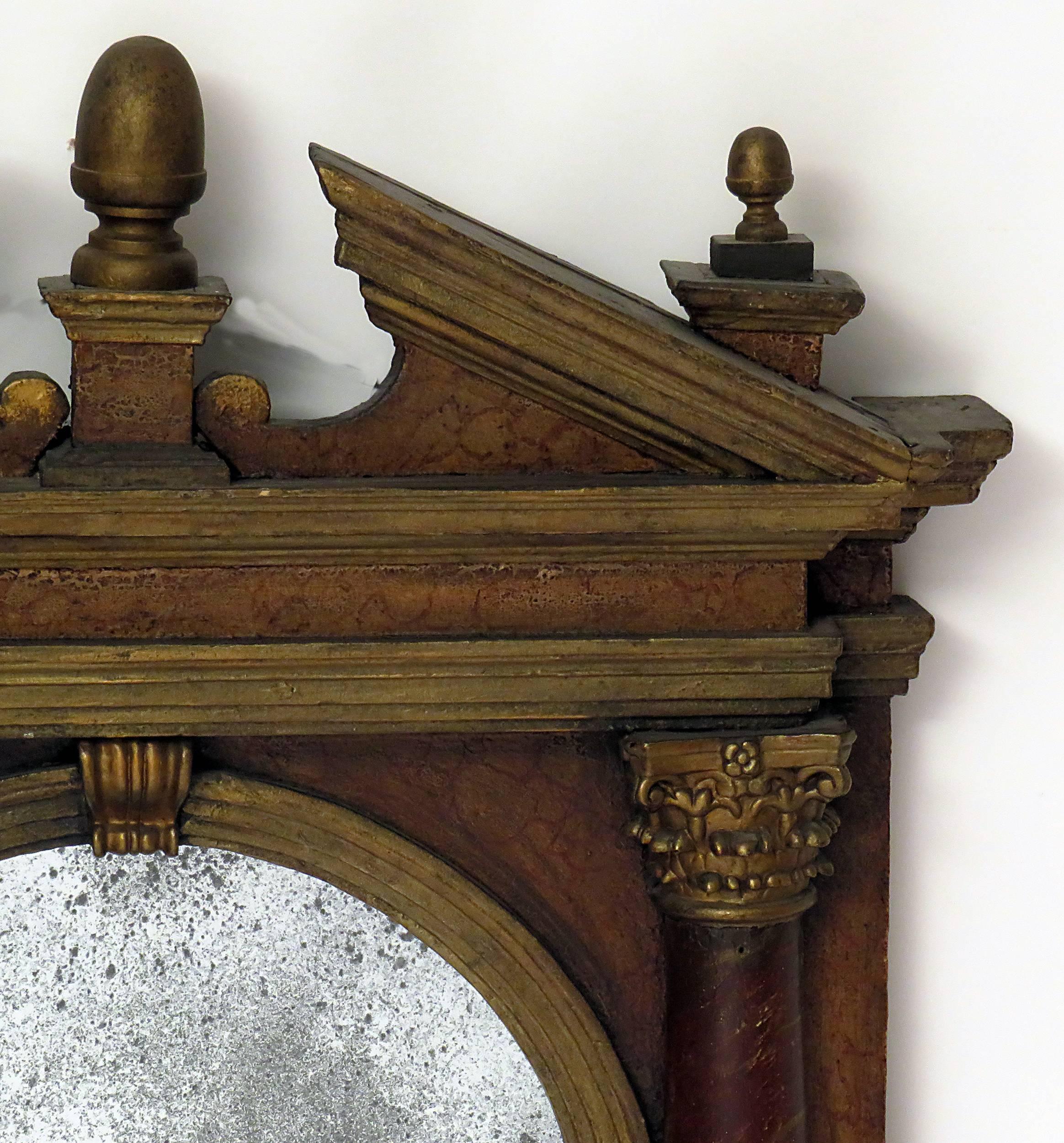 An Italian Baroque Tabernacle frame, circa 1750 painted, part gilt and carved wood with later antiqued mirror. Finial possibly later. A good example of an architectural frame first seen during the Italian Renaissance. Designed based on ancient