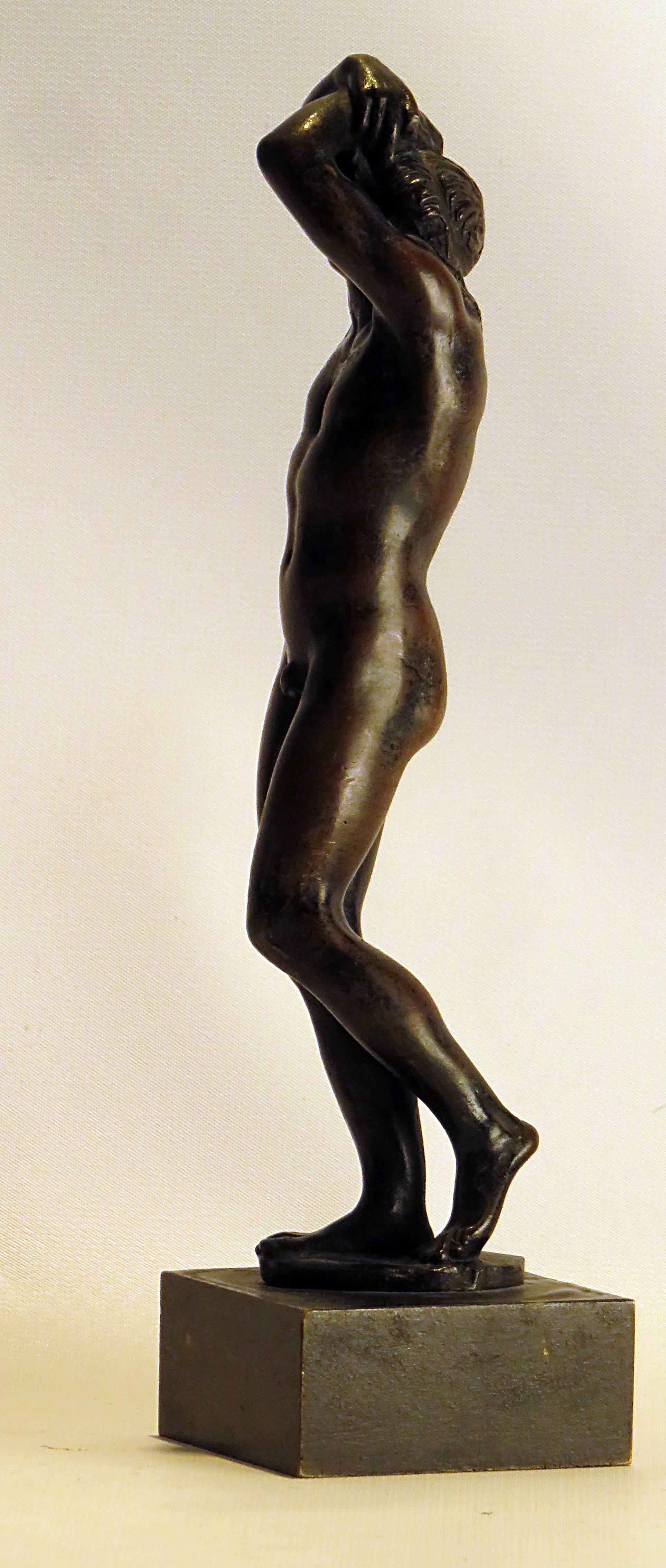 A wonderful casting of a young male nude stretching. This figure reminds us of several similar sculptures.