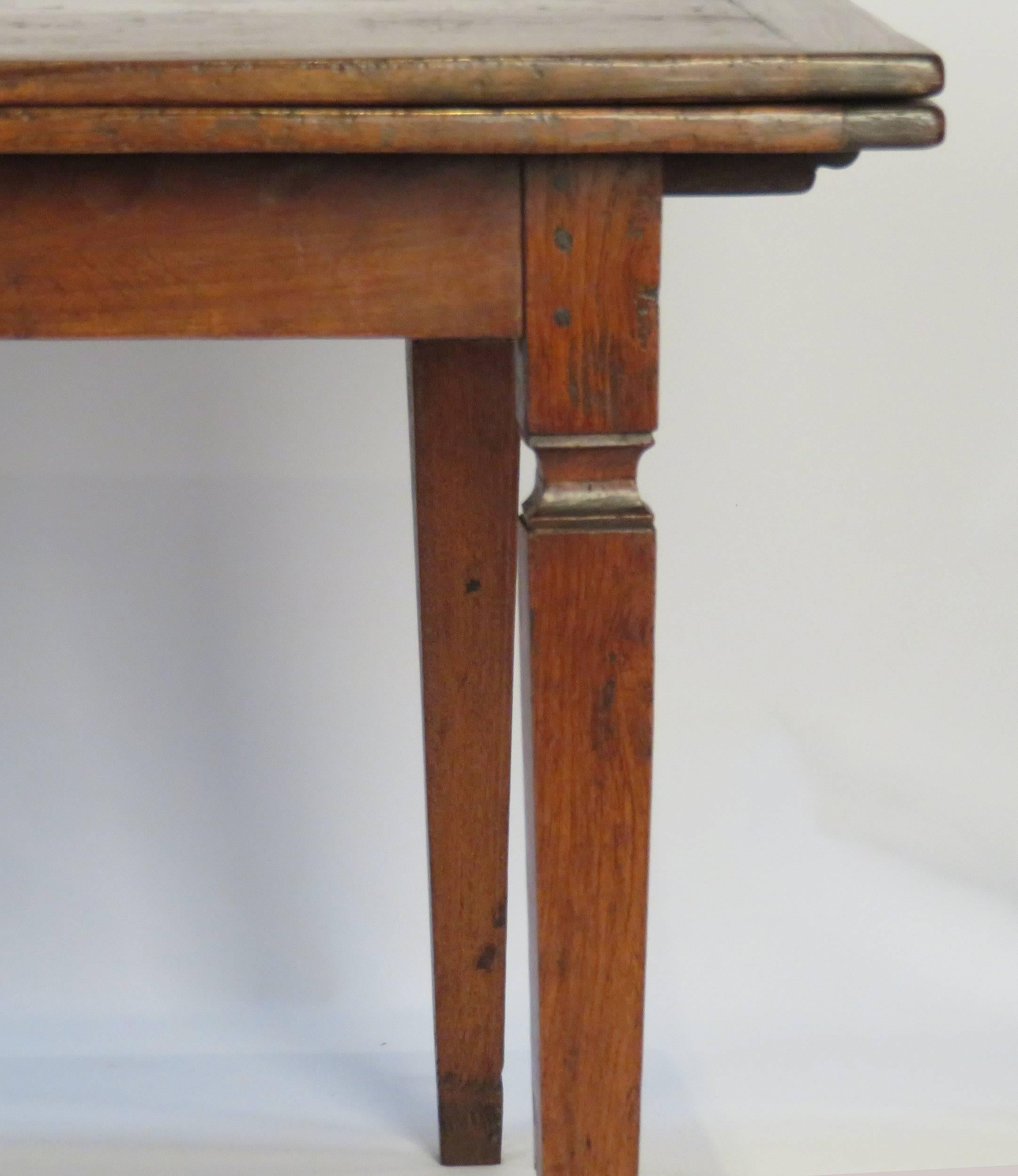 A large and useful farm house table with two draw leafs. Great proportions color and size. We date this to the first part of the 19th century. Measurements are as the table is shown. Fully opened the table extends to 137.5 inches wide.