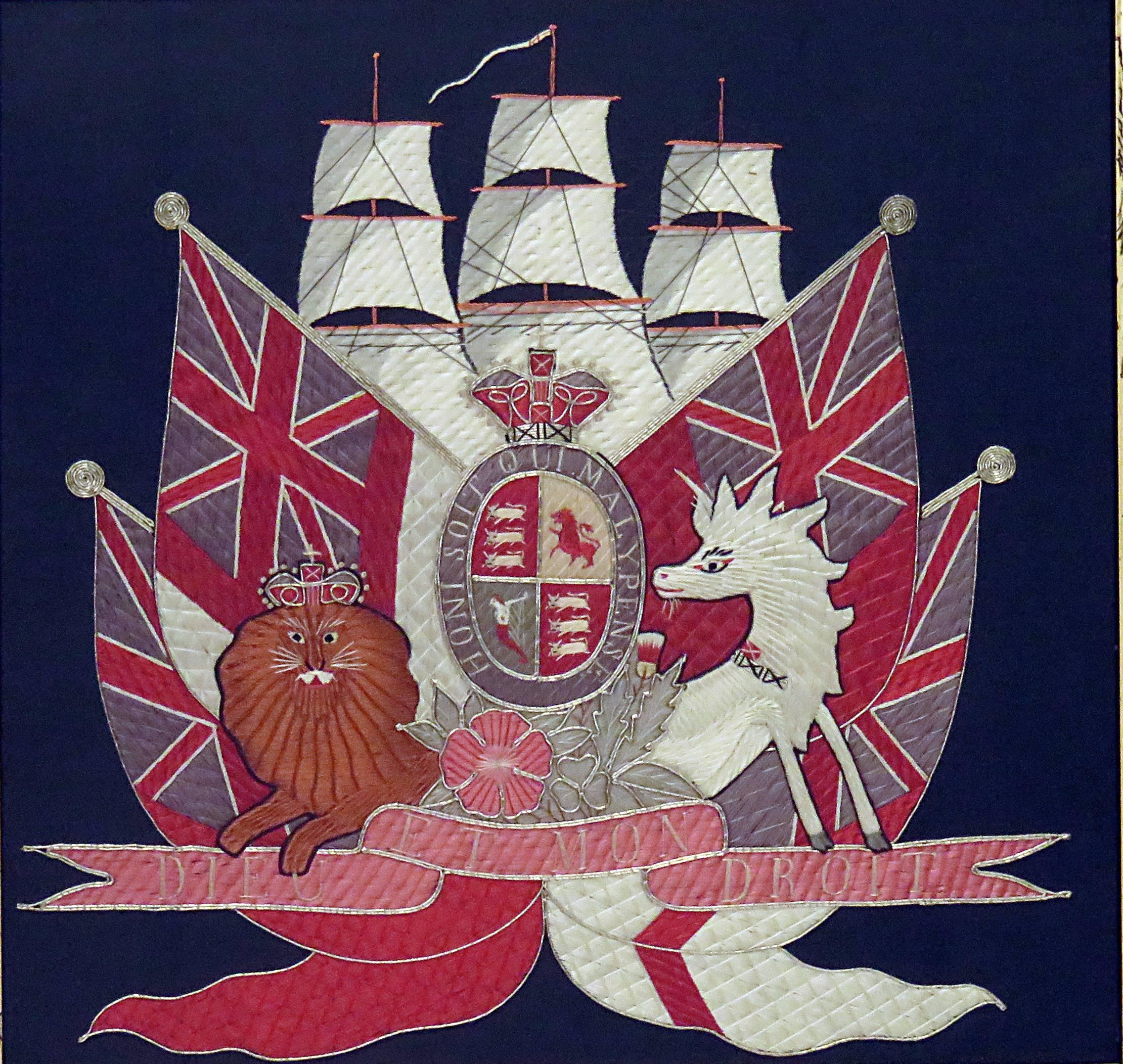 A handsome embroidered picture featuring a British ship under sail with assorted British commonwealth flags. A lion and unicorn frame a cartouche featuring heraldry and the motto of the Order of the Garter. We suspect the work of a talented child as