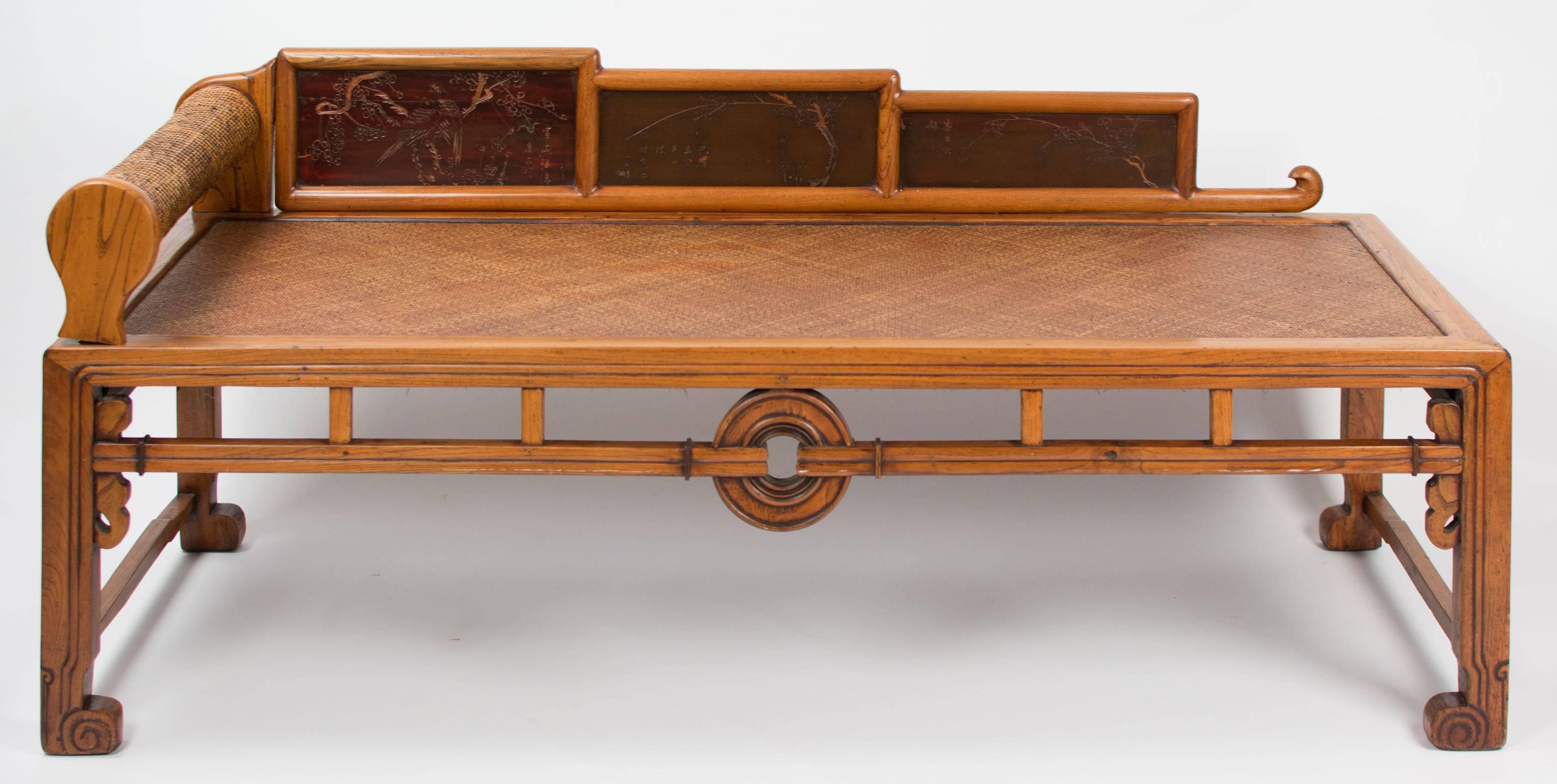 A Chinese elm opium bed with lacquer panels, circa 1880.