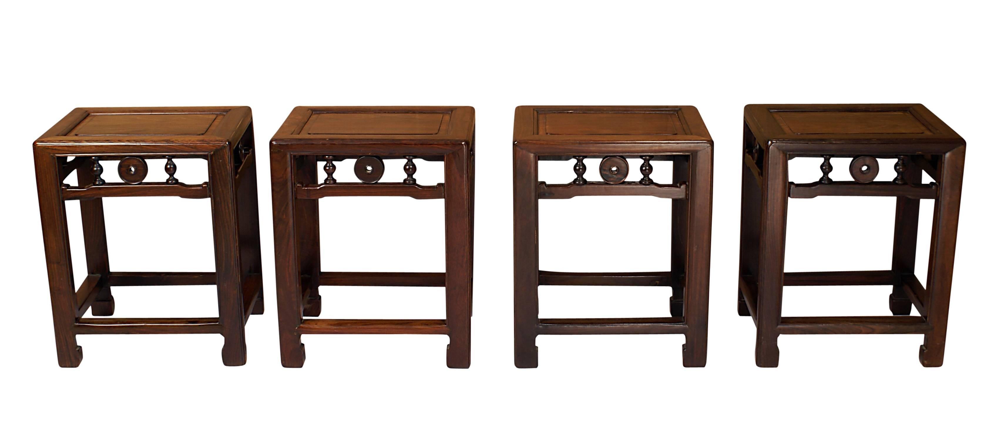 A very good set of four hardwood stools made in China, circa 1920. These show Classic Ming or early Qing Dynasty design. The wood is dense and well figured. These stools are useful as tables and seating.