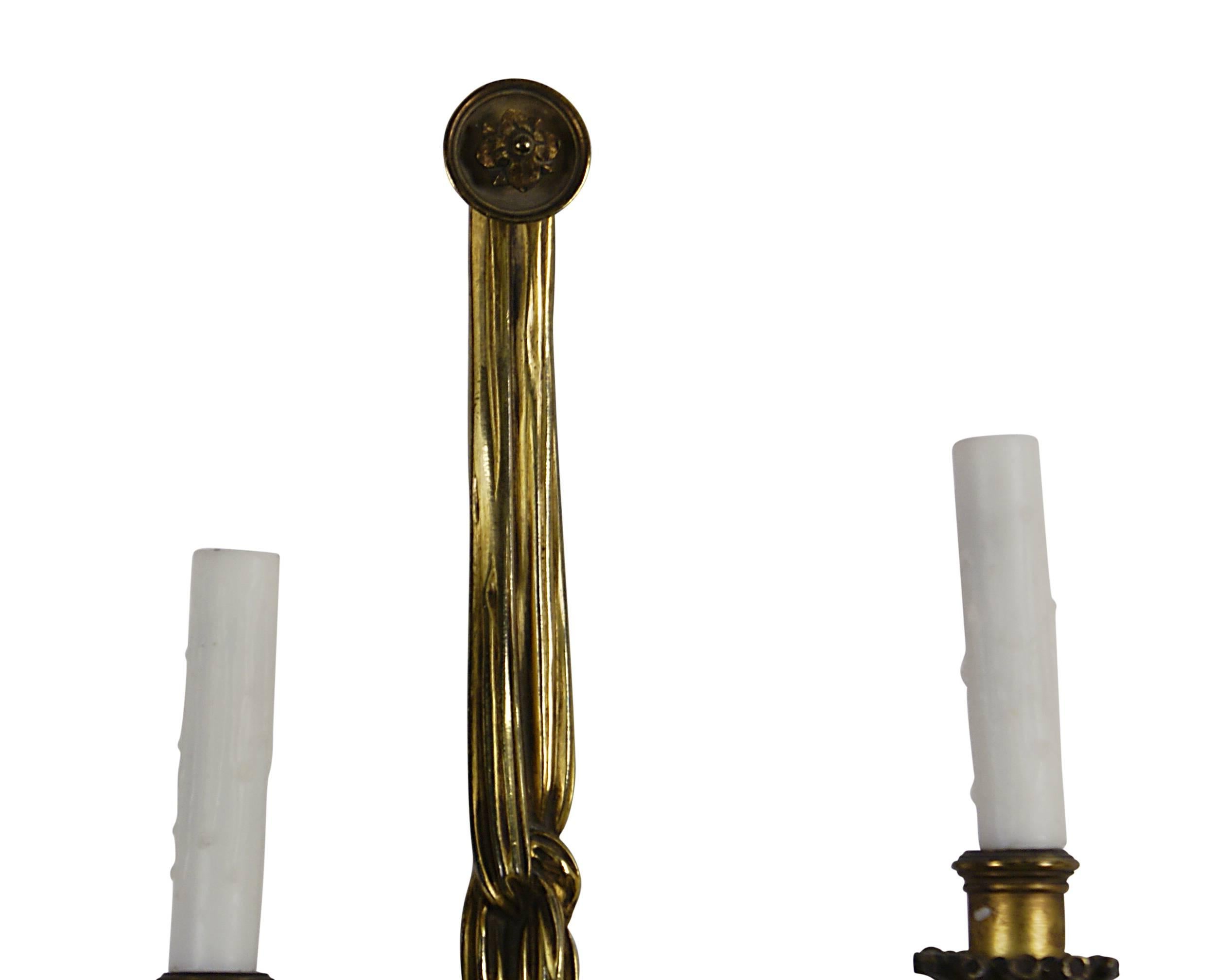 A beautiful pair of gilt bronze two-light sconces now wired for electricity. These are in the style of Louis XVI and have great detail with mellowed patina. From a good collection formed about 100 years ago.