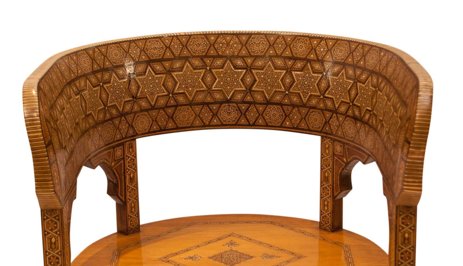 Pair of well inlaid Klysmos chairs made in Morocco, circa 1920. Various hardwoods and camel bone on a hardwood frame. Recently tightened and polished with some small repairs and losses.