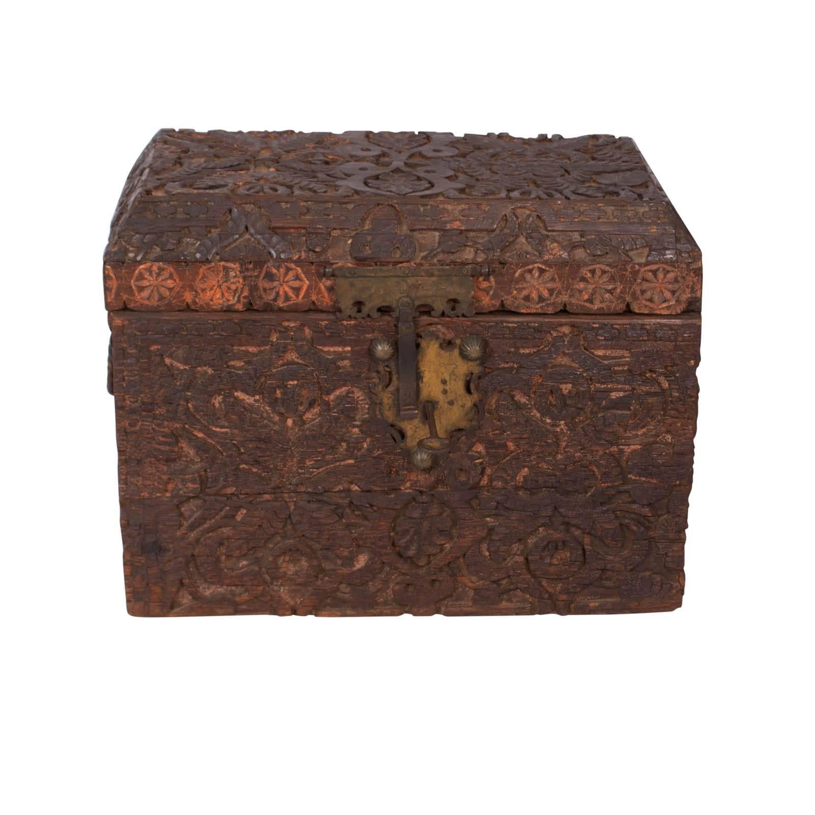 A rustic and handsome Indo-Persian trunk deeply carved with geometric motifs. Made in India or northern Africa, circa 1800 with great old hardware and a coffered top. An interesting rustic trunk that has substantial decorative appeal.