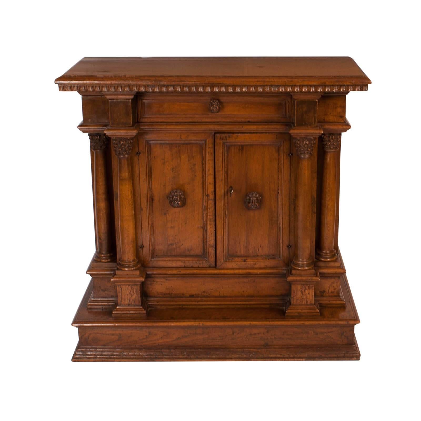 A handsome well carved and detailed Italian walnut Baroque credenza made in Italy, circa 1800. The piece is not orange. Or light image 6 is the best representation of color. The size is particularly useful. The carved faces as handles suggests this