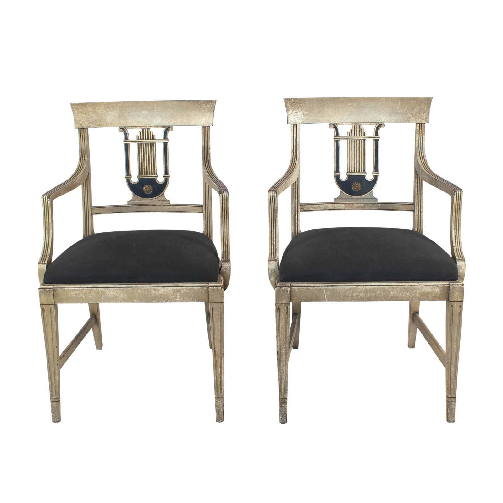 A handsome pair of Hollywood Regency armchairs featuring a carved lyre back a with a good old painted surface. The design was first seen circa 1820 in England but was soon popular all-over the continent. These chairs are solid and comfortable. Best