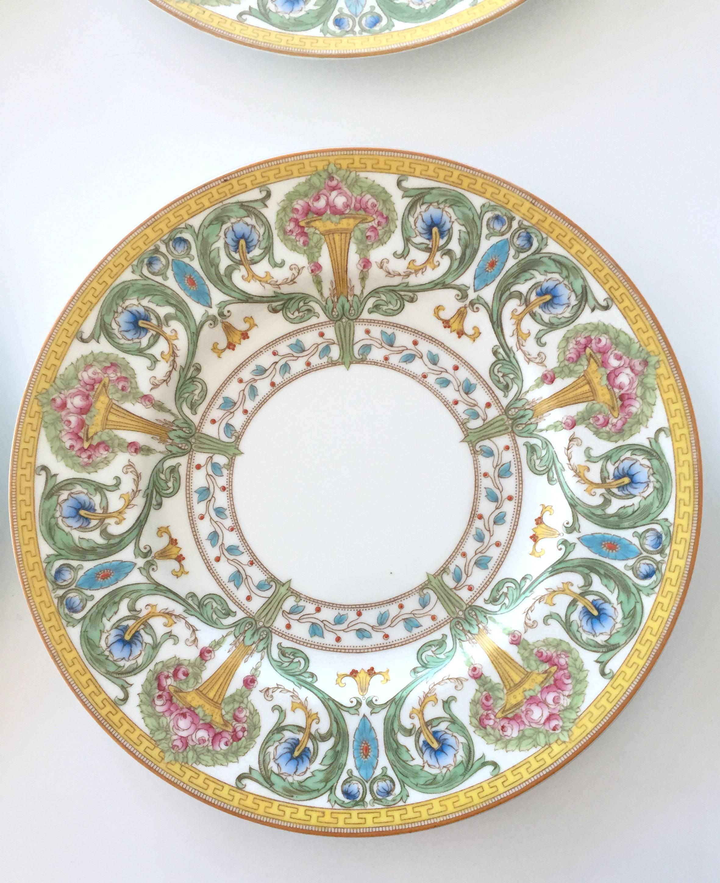 Set of eight Royal Worcester hand-painted plates, signed and numbered with slightly raised bouquets of roses in vases, surrounded by scrolling vines and flowers. The outer border in a Greek Key pattern and the inner border featuring scrolling flower