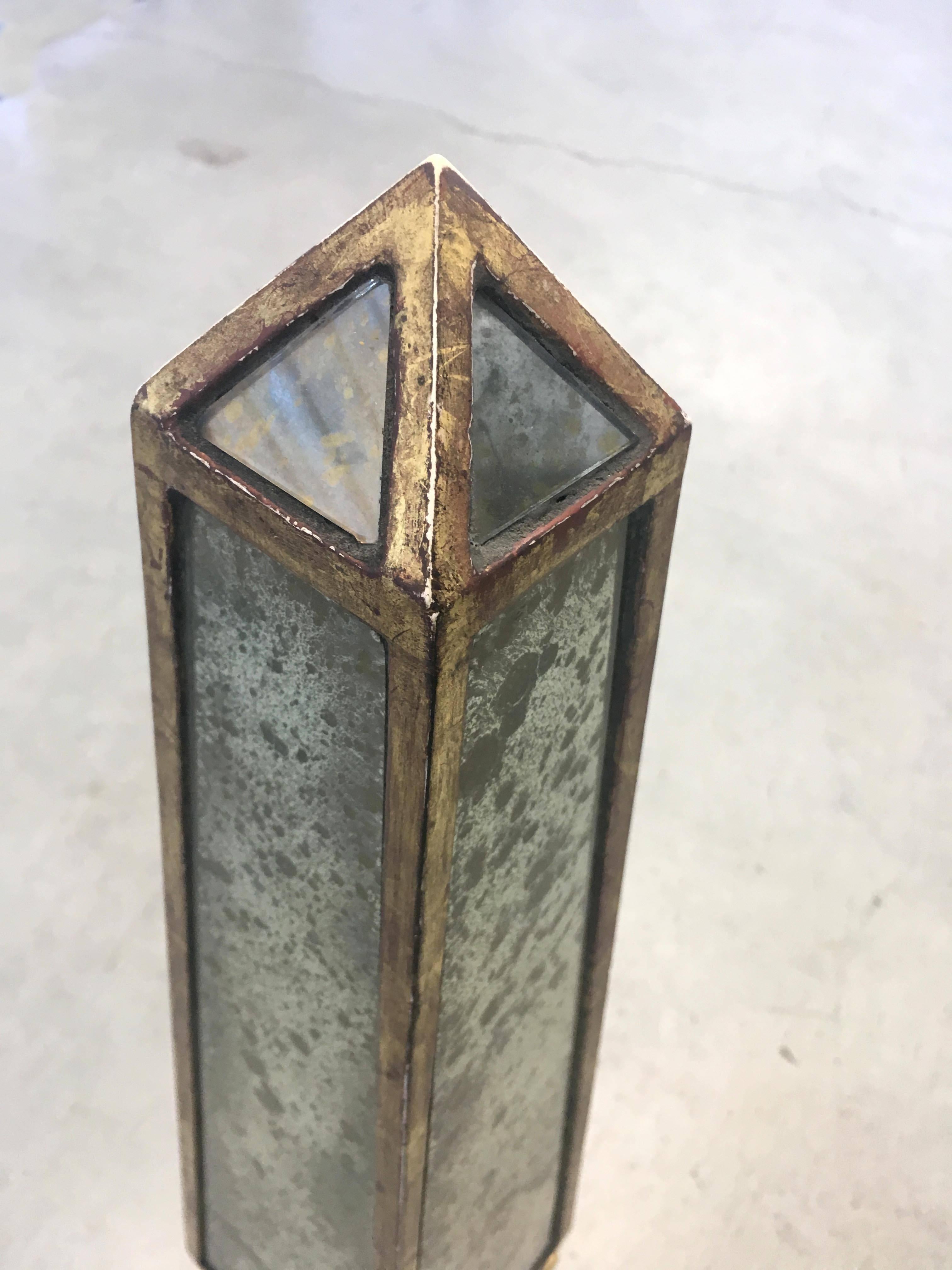 Pair of Classic obelisks composed of antique gold mirror with rubbed white gold leaf armature on ball feet atop plinth base.

 