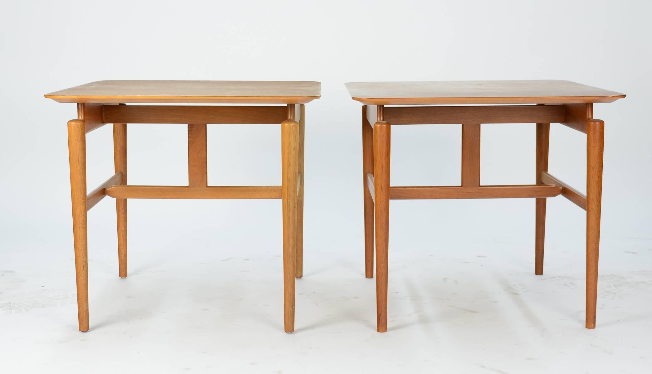 These elegant side tables are from the line that modern Danish master Finn Juhl did for furniture company Baker of Holland Michigan. They have the appearance of having floating top and lightness that is a trade mark of Juhl's designers. Both table