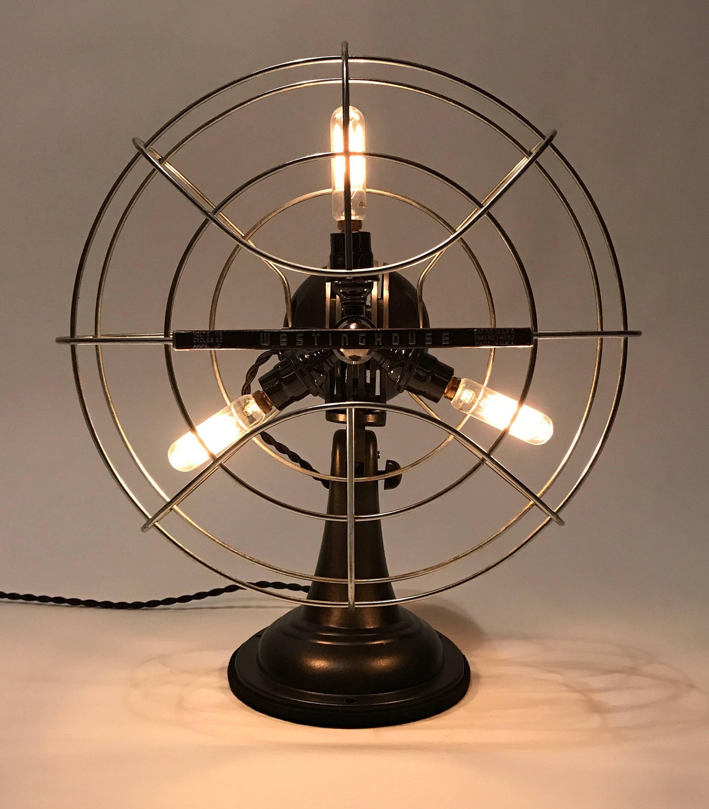 Vintage 12" Westinghouse fan repurposed as a lamp. The metal housing has been meticulously refinished and restored. 

Painted metal and oil-rubbed bronze with chrome accents. Wired professionally by a licensed electrician with all UL listed
