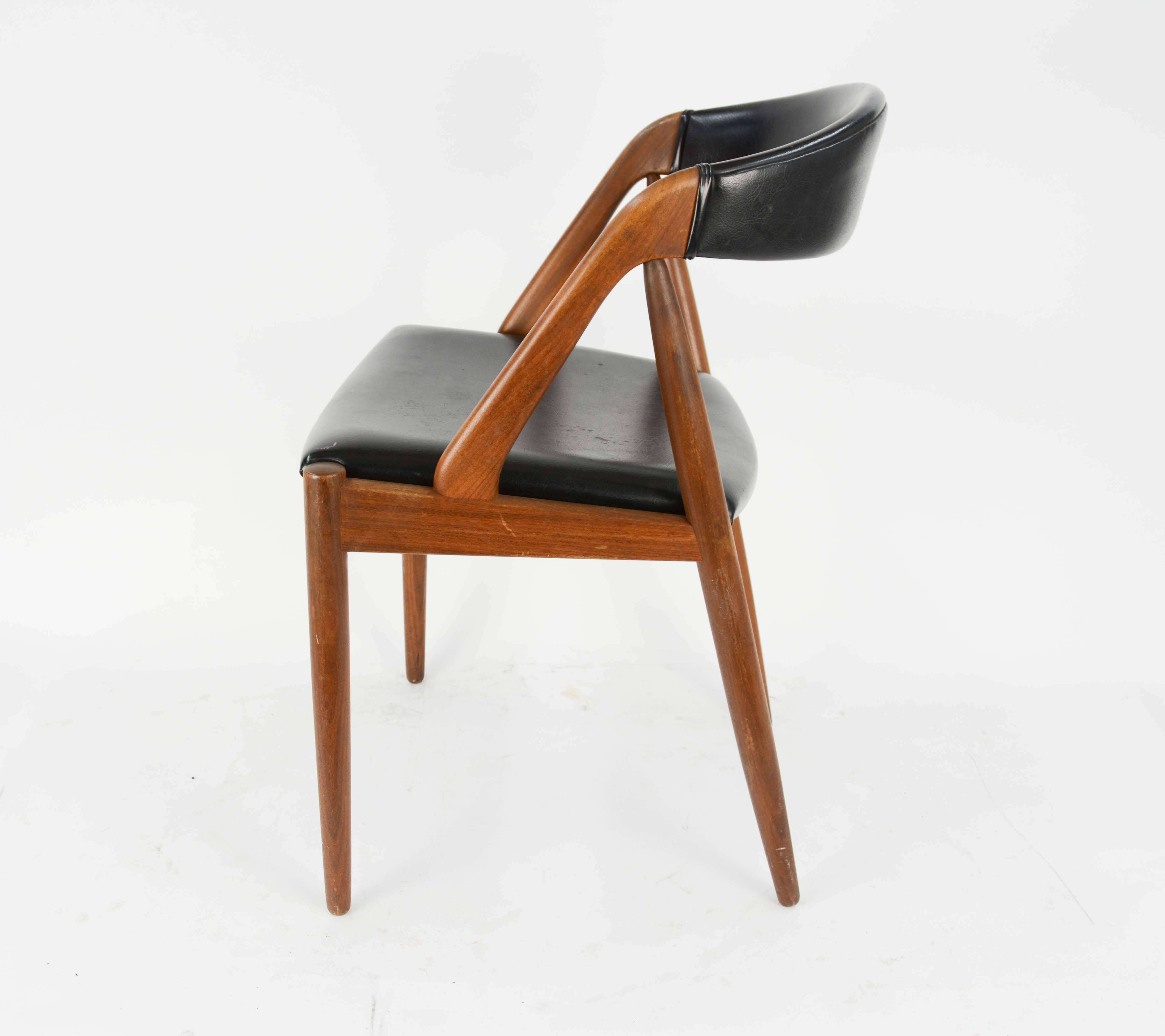 A set of four Kai Kristiansen model 31 teak dining chairs with leatherette.