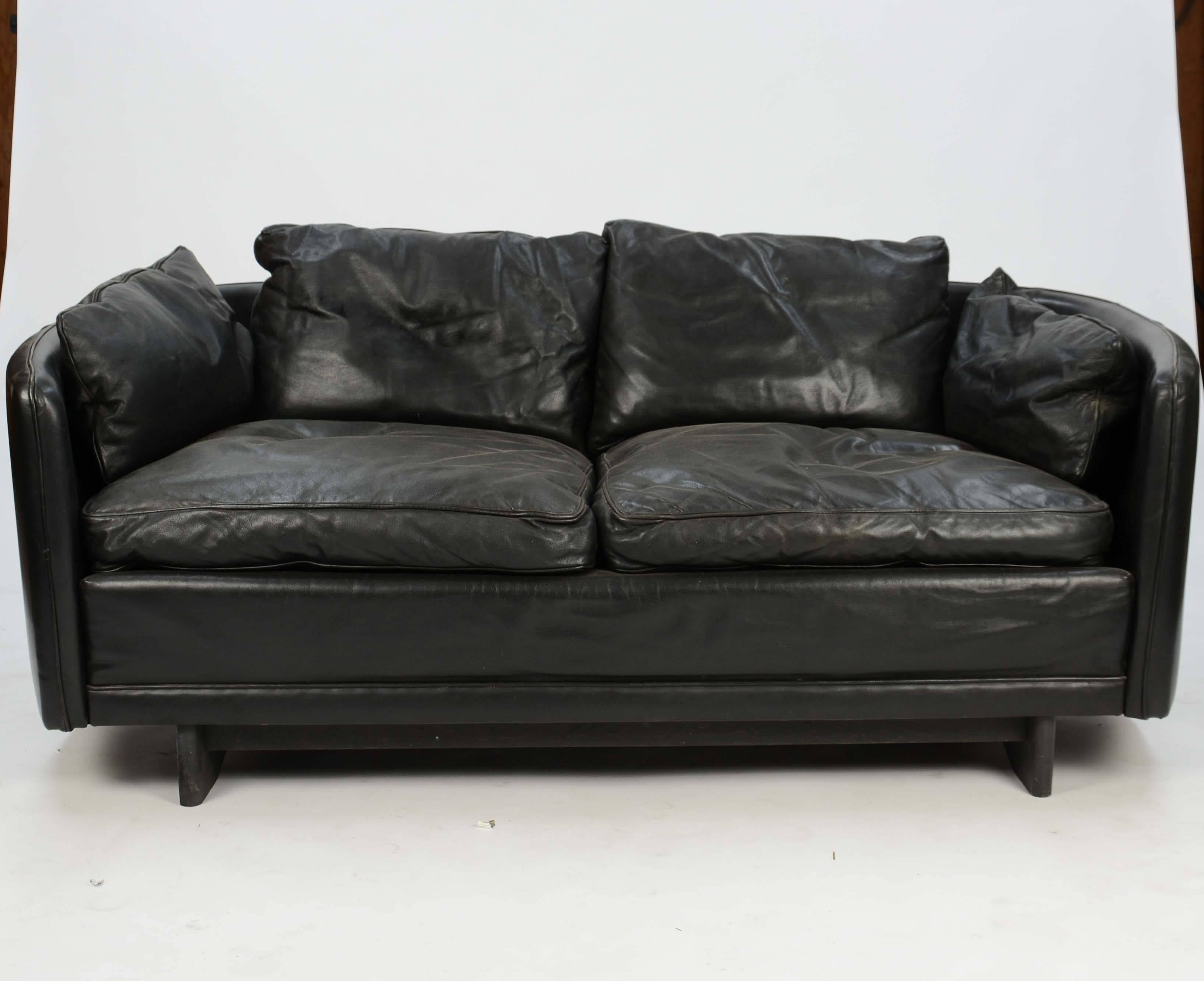Hans Olsen loveseat in distressed leather with handsome baseball stitching. The loveseat is a surround back.