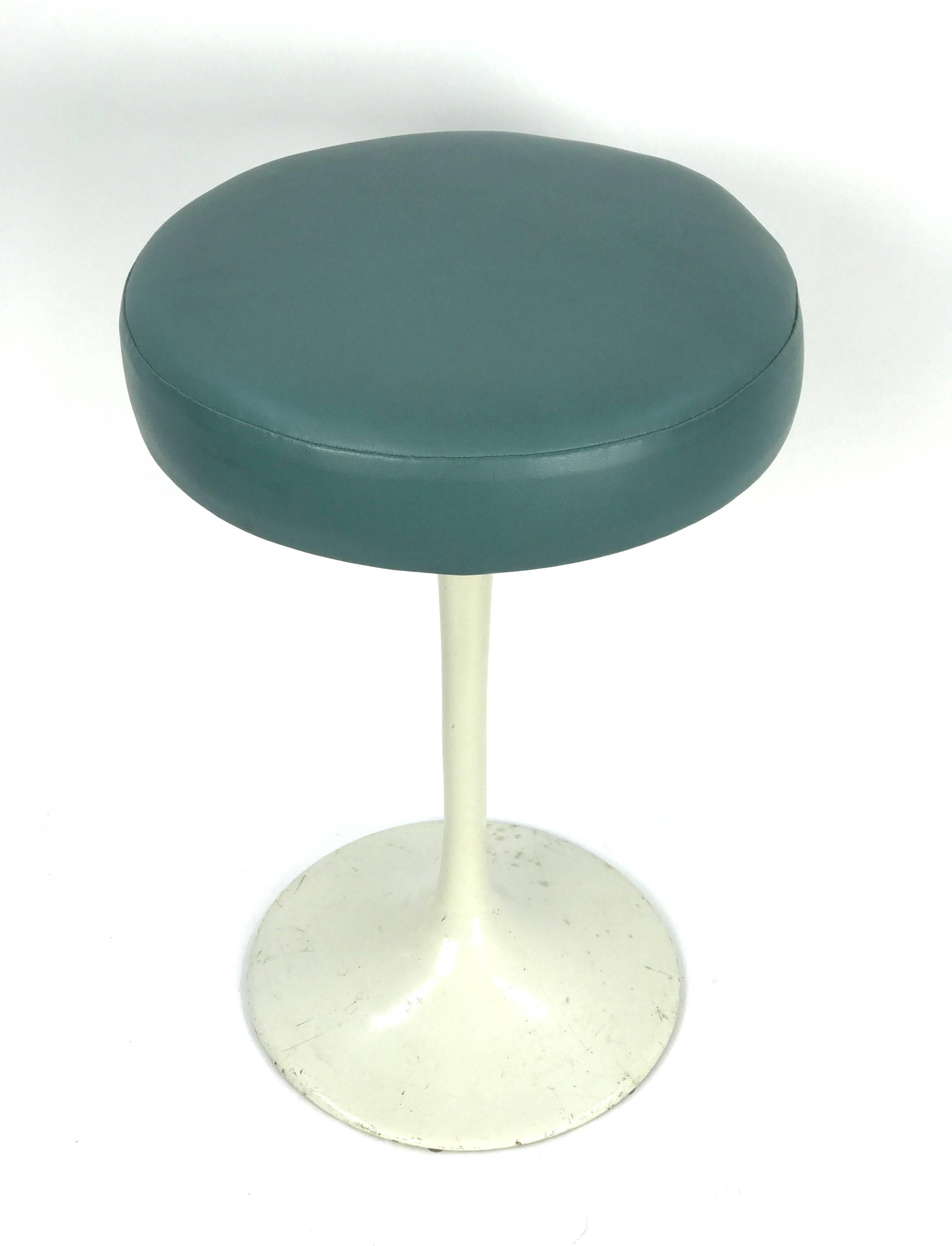 A classic and early tulip stool designed by Eero Saarinen for Knoll.

Newly reupholstered in deep aqua vinyl on an enameled cast iron base. (Knoll label lost during reupholstering).
 