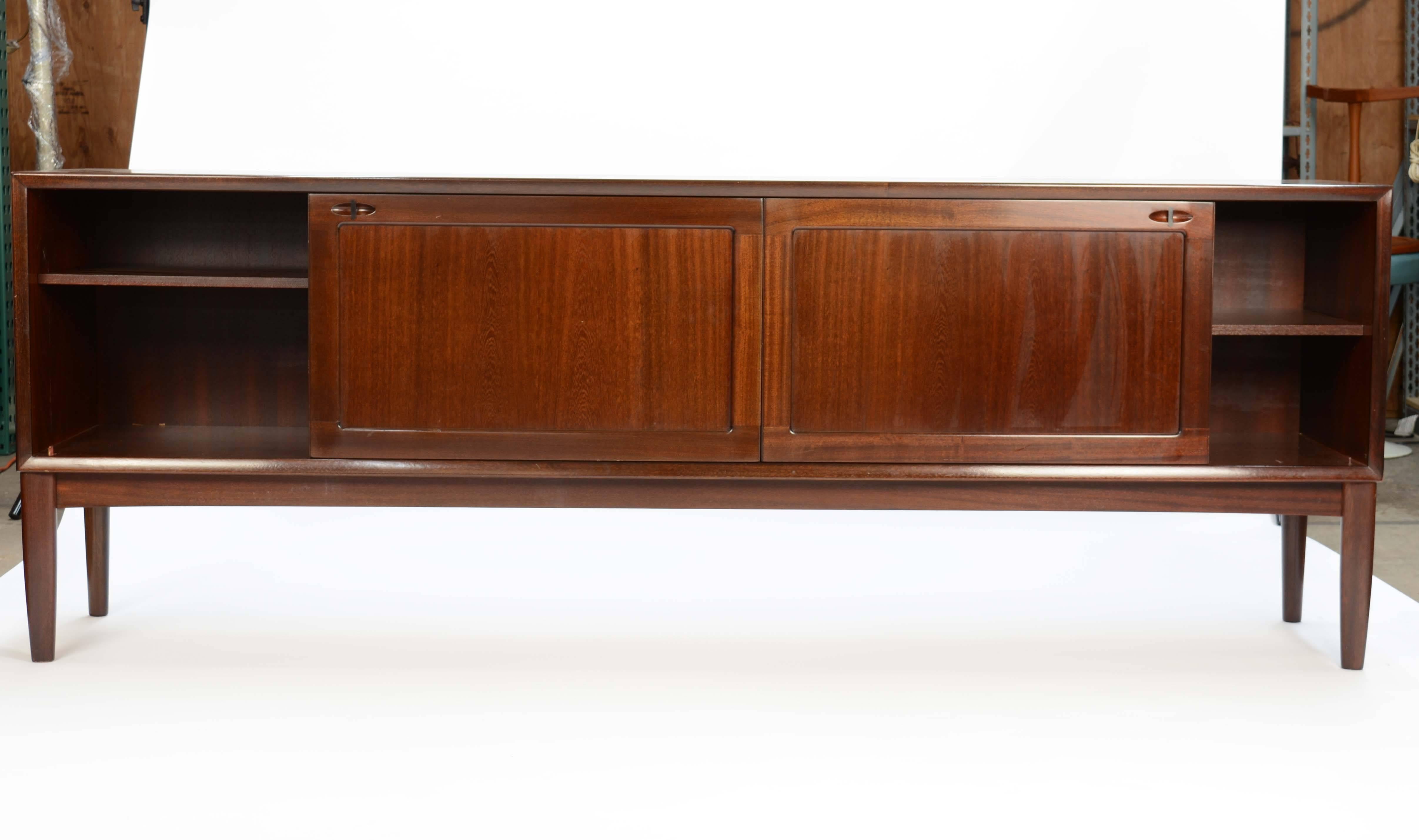 High quality mahogany sideboard. Designed by Henry W.Klein. Front with four drawers and two sliding doors. Behind sliding doors with shelves. Produced by Bramin Denmark. Freestanding.