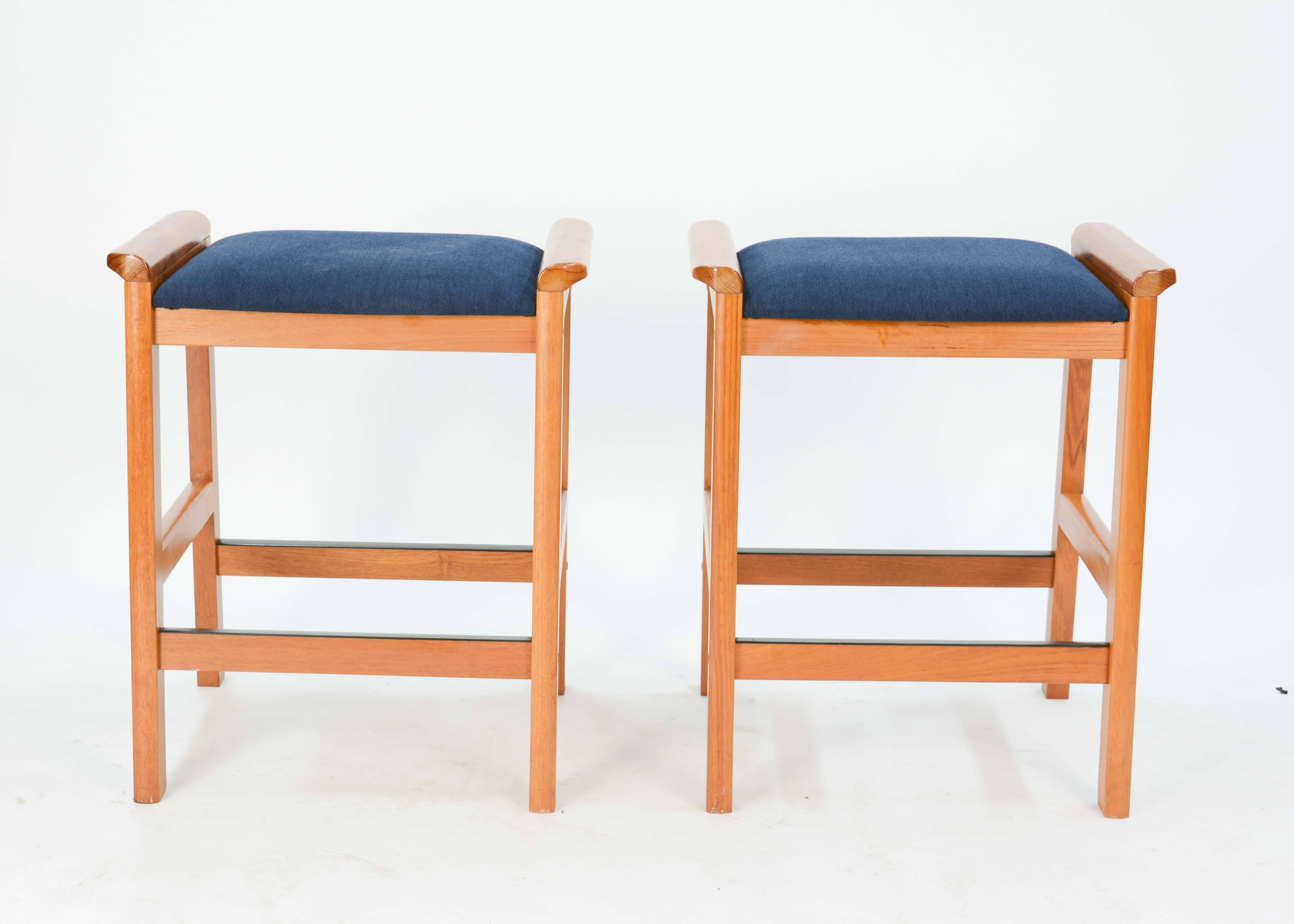 A Pair of J.L. Moller-Hojbjerg Danish Modern Bar Stools with new Royal Blue Fabric.  These stools feature the flair side handles and foot rest.