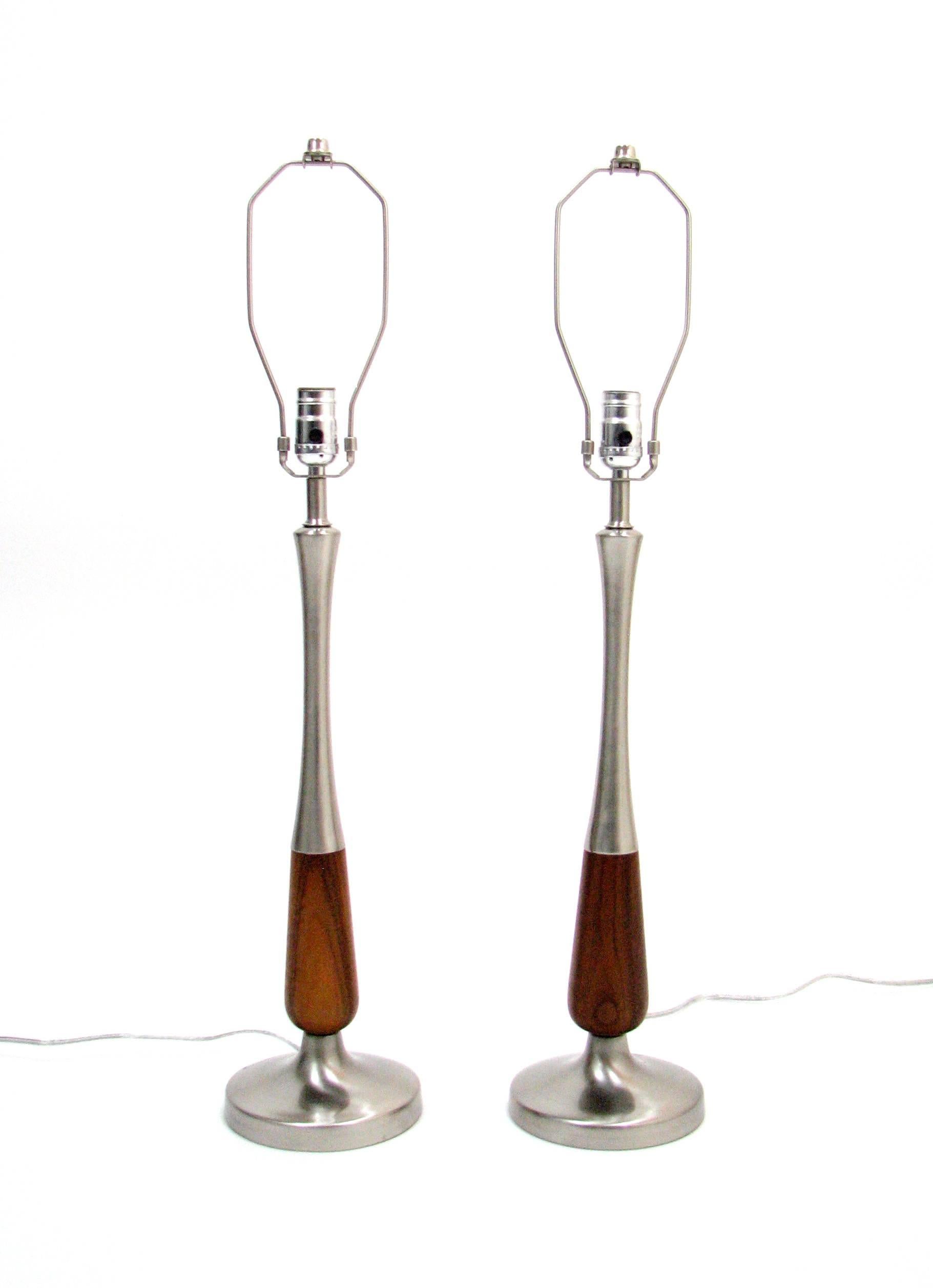 A beautiful pair of Midcentury walnut and brushed nickel lamps.  Originally plated in brass, the molded steel sections have been re-plated in brushed nickel and the walnut has been refinished for new life in the 21st century.

These lamps are 20