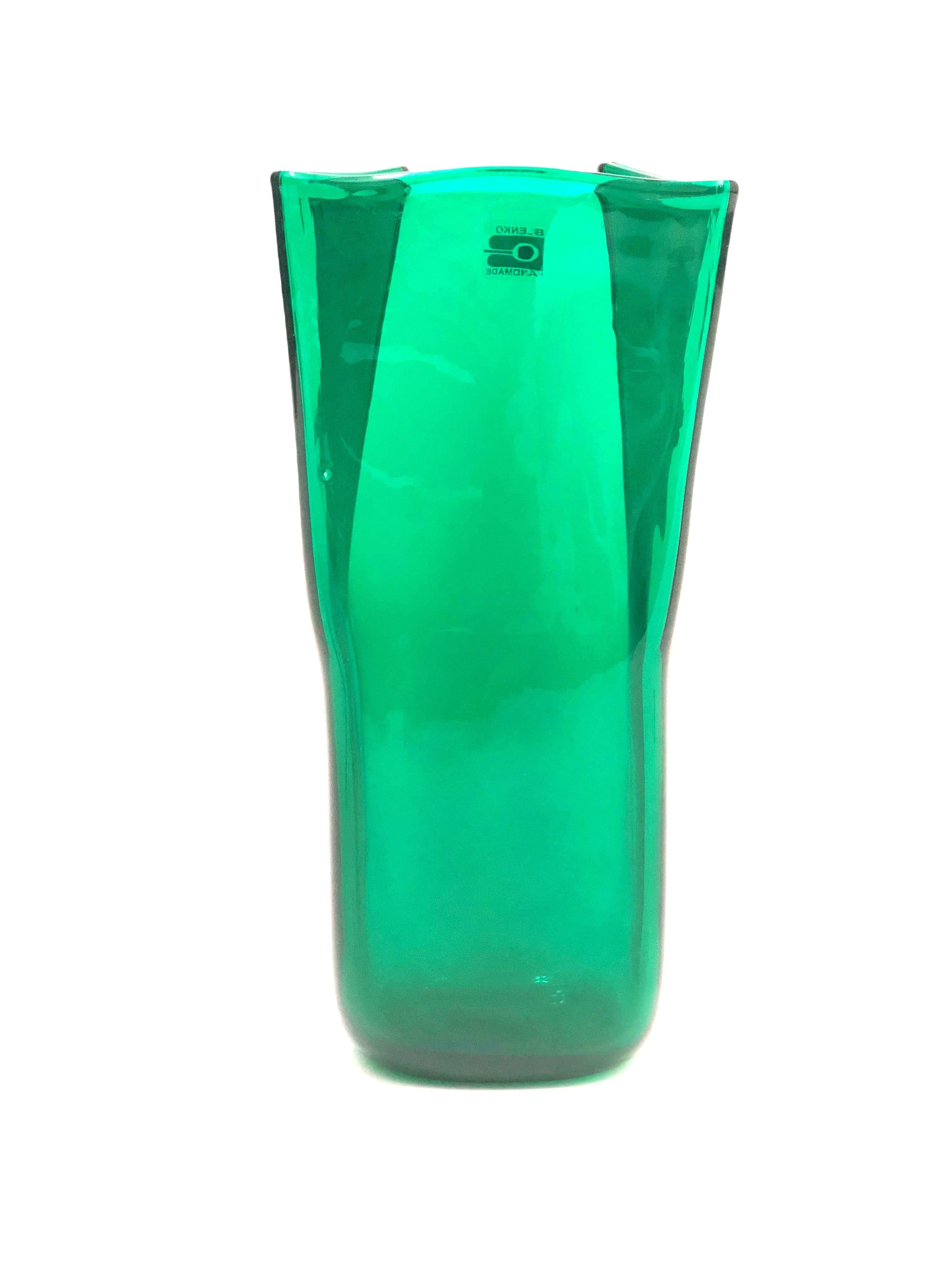 An elegant midcentury green folded glass vase by Don Shepherd for Blenko.

Don Shepherd (1930-2002) was a noted Connecticut artist and designer who worked for Blenko from 1974 to 1988. After leaving Blenko, he became a designer for Herman Miller.