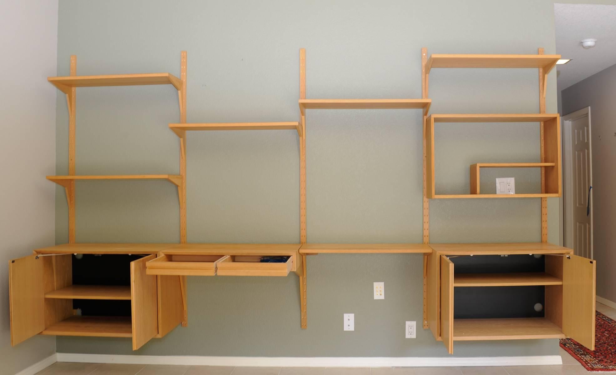 A 12 foot wall unit with six shelves. Two cupboard and a desk. All from owner and in.