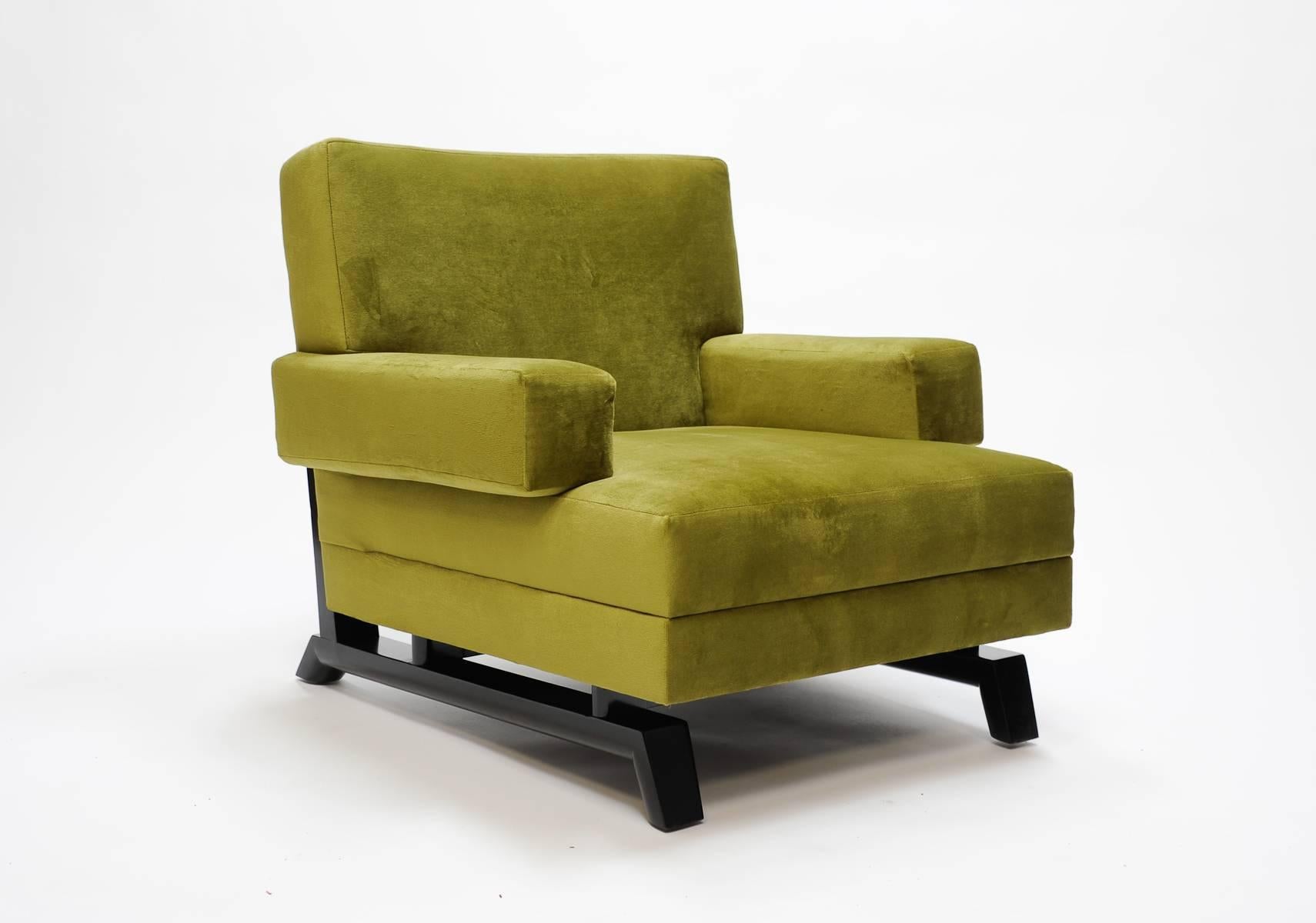 A wonderful pair of Paul Laszlo club chairs upholstered in green velvet. Arm Height is 20