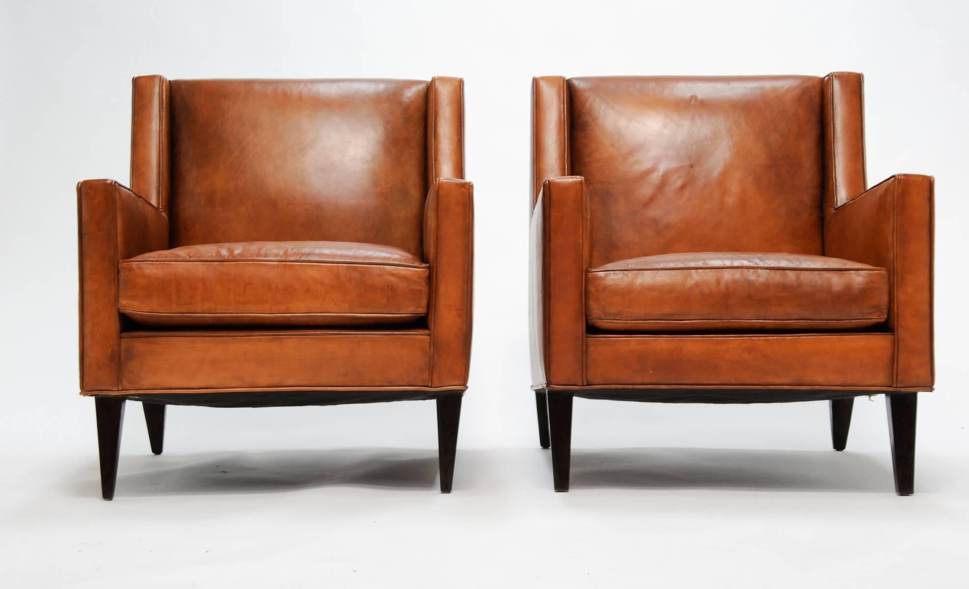The simple and eleganance of the modern master is clear in this pair of leather chairs by Edward Wormley for Dunbar. The chairs are the excellent build quality of the Dunbar company. Arm height is 23