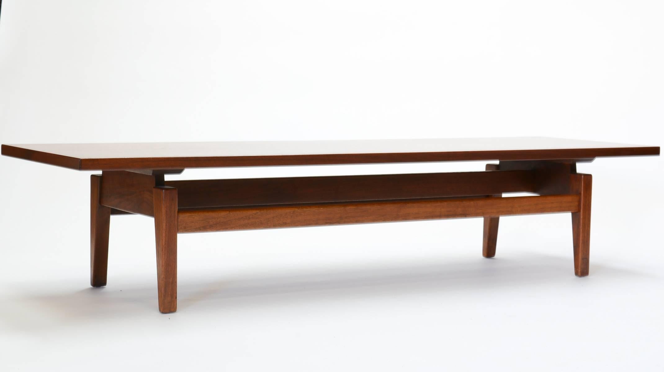 A very large Jens Risom coffee table for Jens Risom Design. The table is from his line that floats on top of the bench and tabletop. Simple and elegant in their design. A fine example from a modern master.