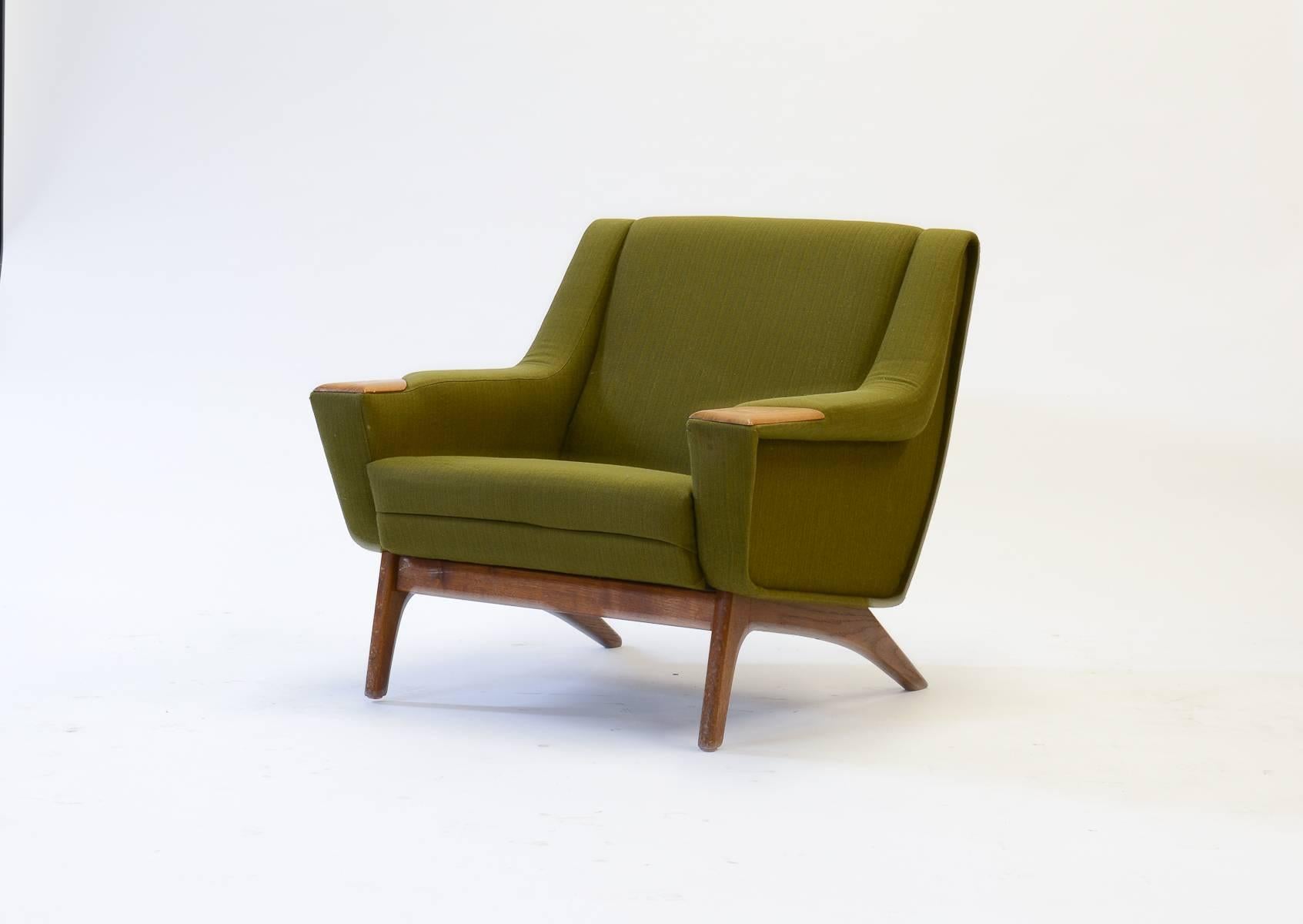 A pair of Danish flared-leg club chairs with teak 'paw' armrests, a beautiful coupling of Danish design and Italian refinement. Simple and spacious in form and function, in the manner of Kai Kristiansen.