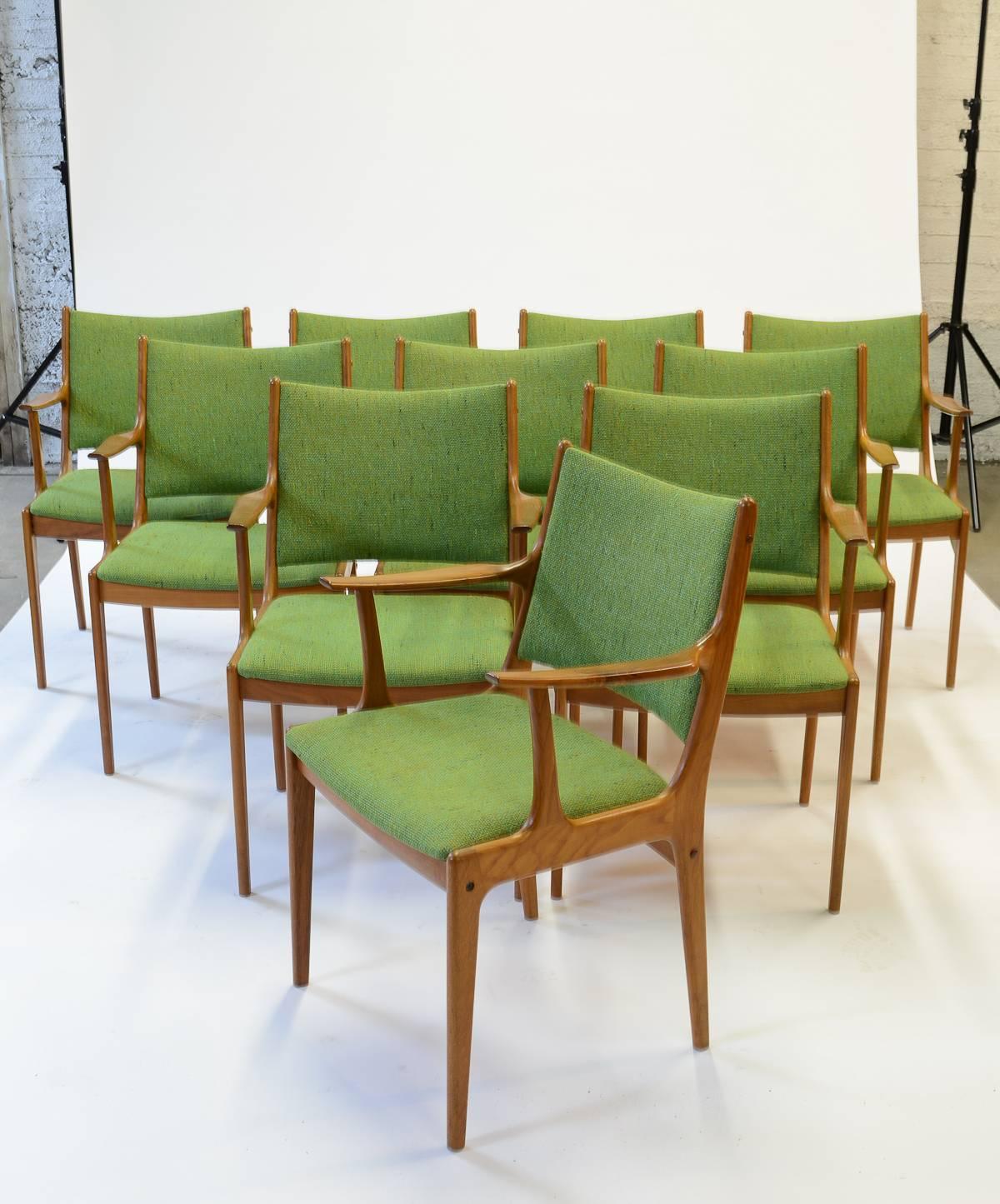 An Impressive set of Johannes Andersen armchairs for Uldum Modelfabrik with green fabric by Nanna Ditzel Hallingdal. The full set of ten armchairs are crafted in teak.

It is believed that Andersen initially apprenticed as a cabinetmaker. He went