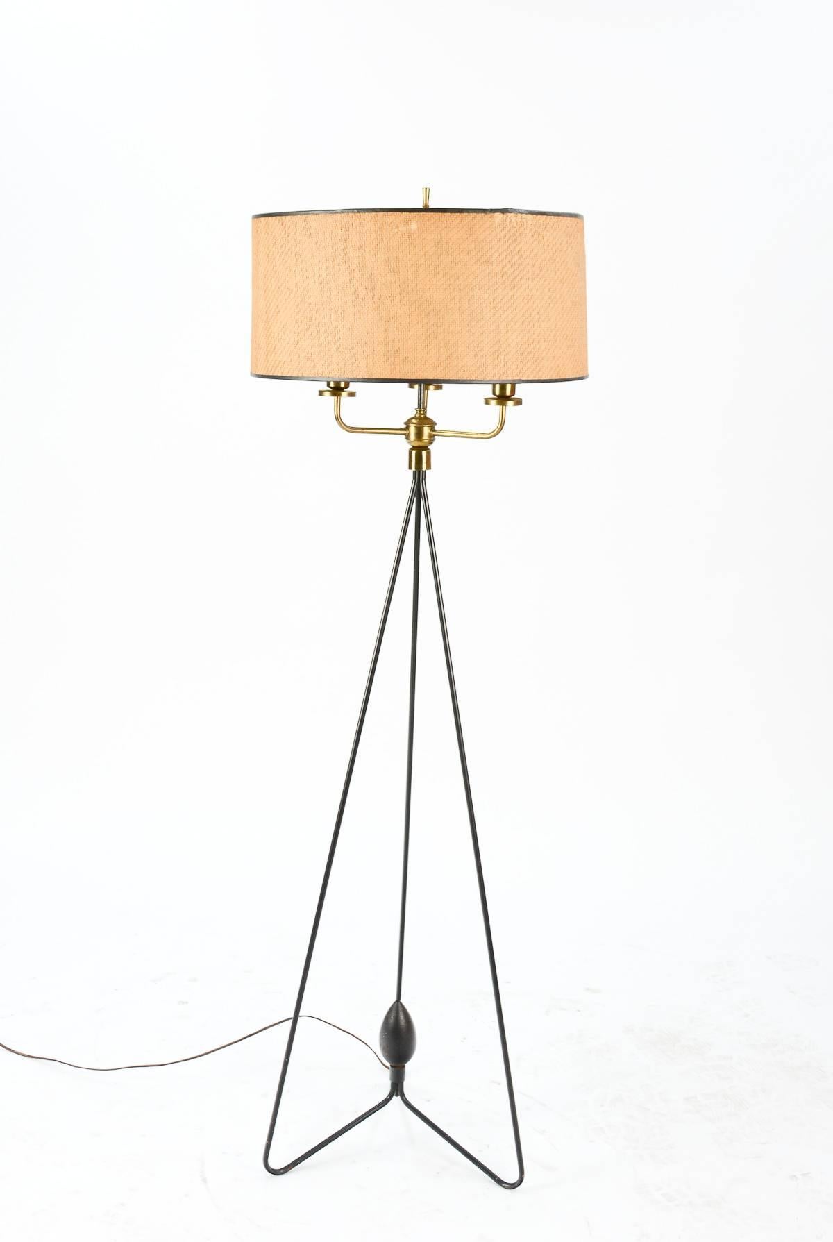 A rare and elegant Gerald Thurston iron tripod floor lamp with a whimsical acorn center piece at the base.

Offered with shade, which is 9 inches high by 18 inches in diameter.