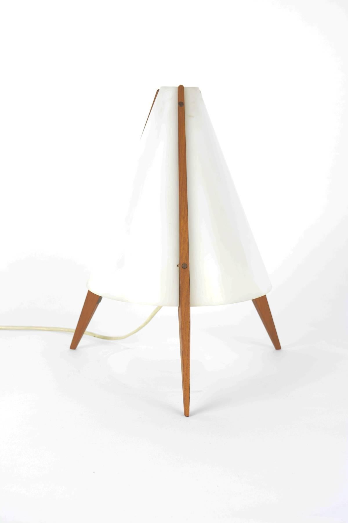 A wonderful 1954 example of Swedish designer Hans-Agne Jakobsson's lighting designs for AB Markaryd. Made of plexiglass and teak legs tapered to a Fine point. The lamp has its original tag.

Swedish interior decorator and furniture designer