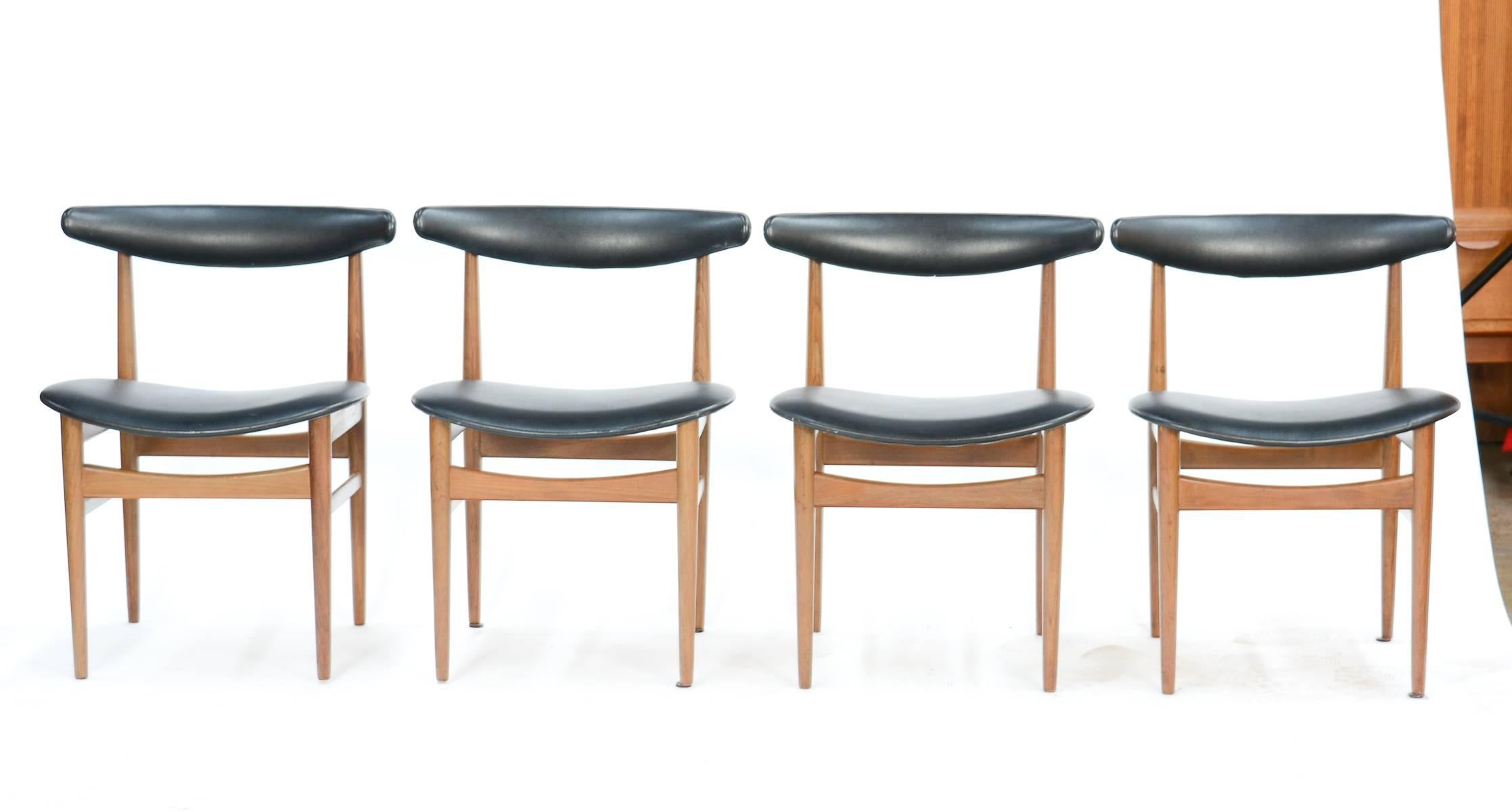 Inspired by modern Danish master Hans Wegner, this set of eight compass-back chairs in teak with black vinyl back rests and seats delivers simple, yet marvellous sophistication. Exquisite style from the height of the Mid-Century Danish design