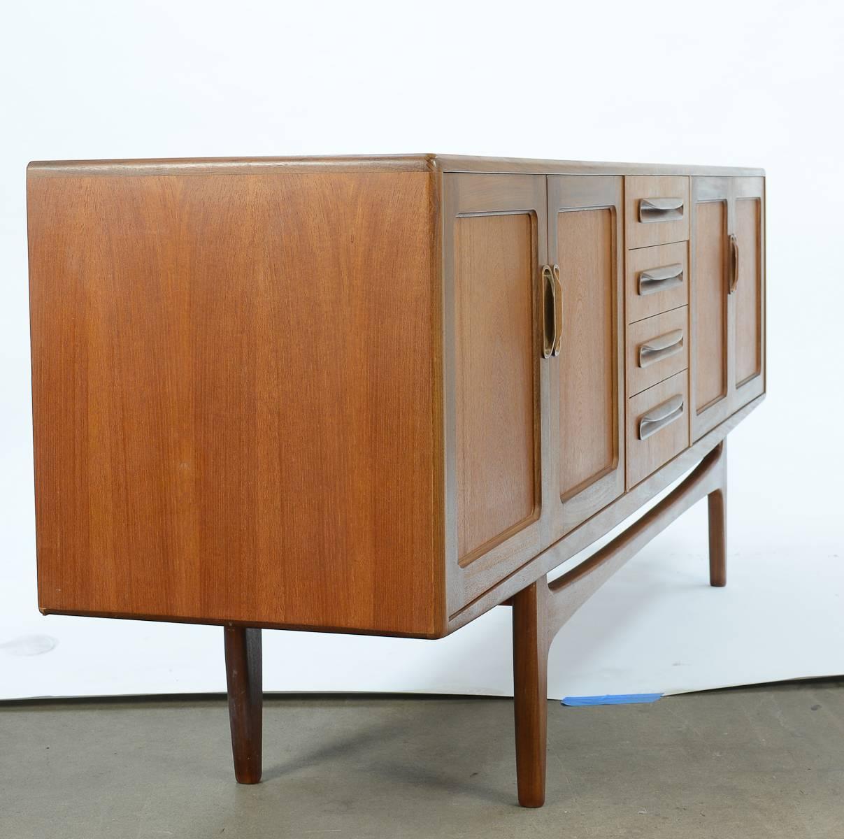 A truly grand teak credenza by Ib Kofod-Larsen for G Plan.

Danish Mid-Century design leader Kofod-Larsen (1921-2003) frequently worked with gorgeous woods, such as teak and rosewood, as well rich leathers. Clean, sculptural lines characterize
