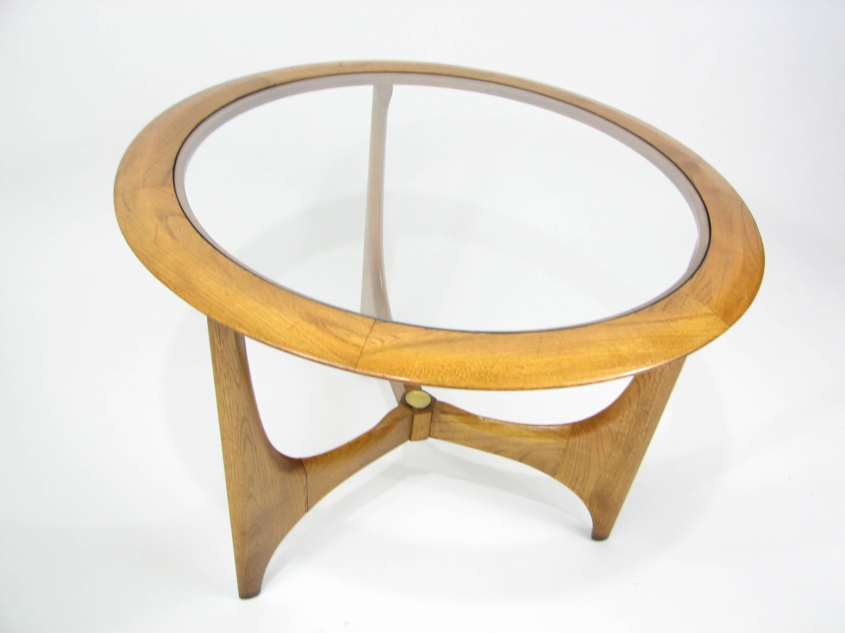 This beautiful round Mid-Century side table by Lane is made of walnut with a brass medallion accent at the center intersection of the legs. 

Light original finish. The glass top is in excellent condition.

There is a minor nick on one “arm” of