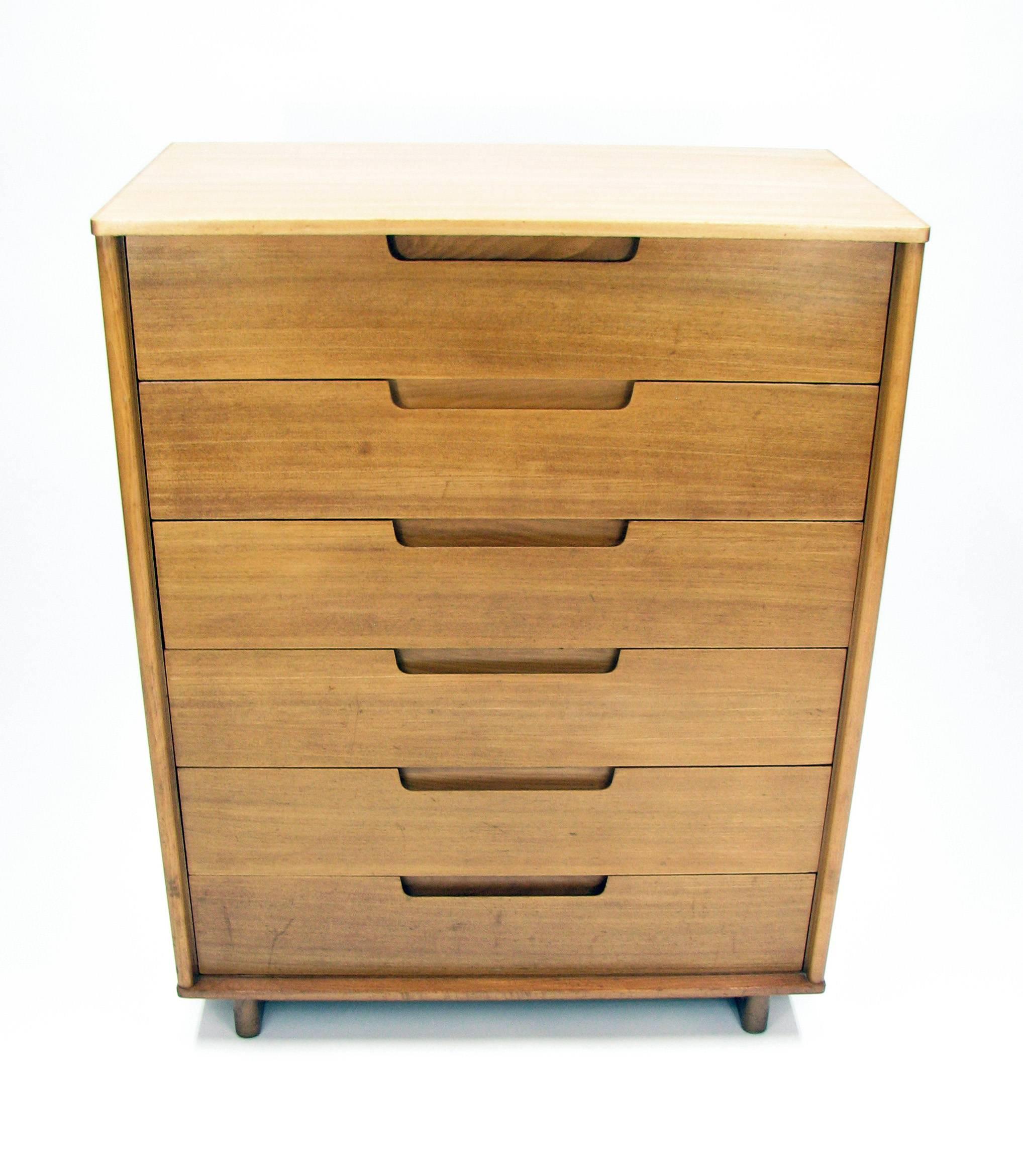 This handsome Mid-Century chest of drawers is an important early piece by Milo Baughman, created for Drexel “Today’s Living” collection. This six-drawer dresser was produced in figured elmwood in 1953 (stamped documentation on the back). The top