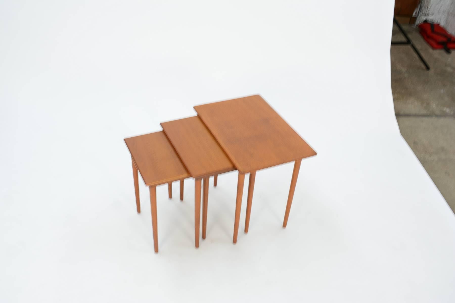 This trio of neatly nesting Danish Mid-Century teak side tables will maximize your space while elevating your style. Their timeless clean-lined design also means they'll blend with a variety of decor styles and provide extra cocktail tables for