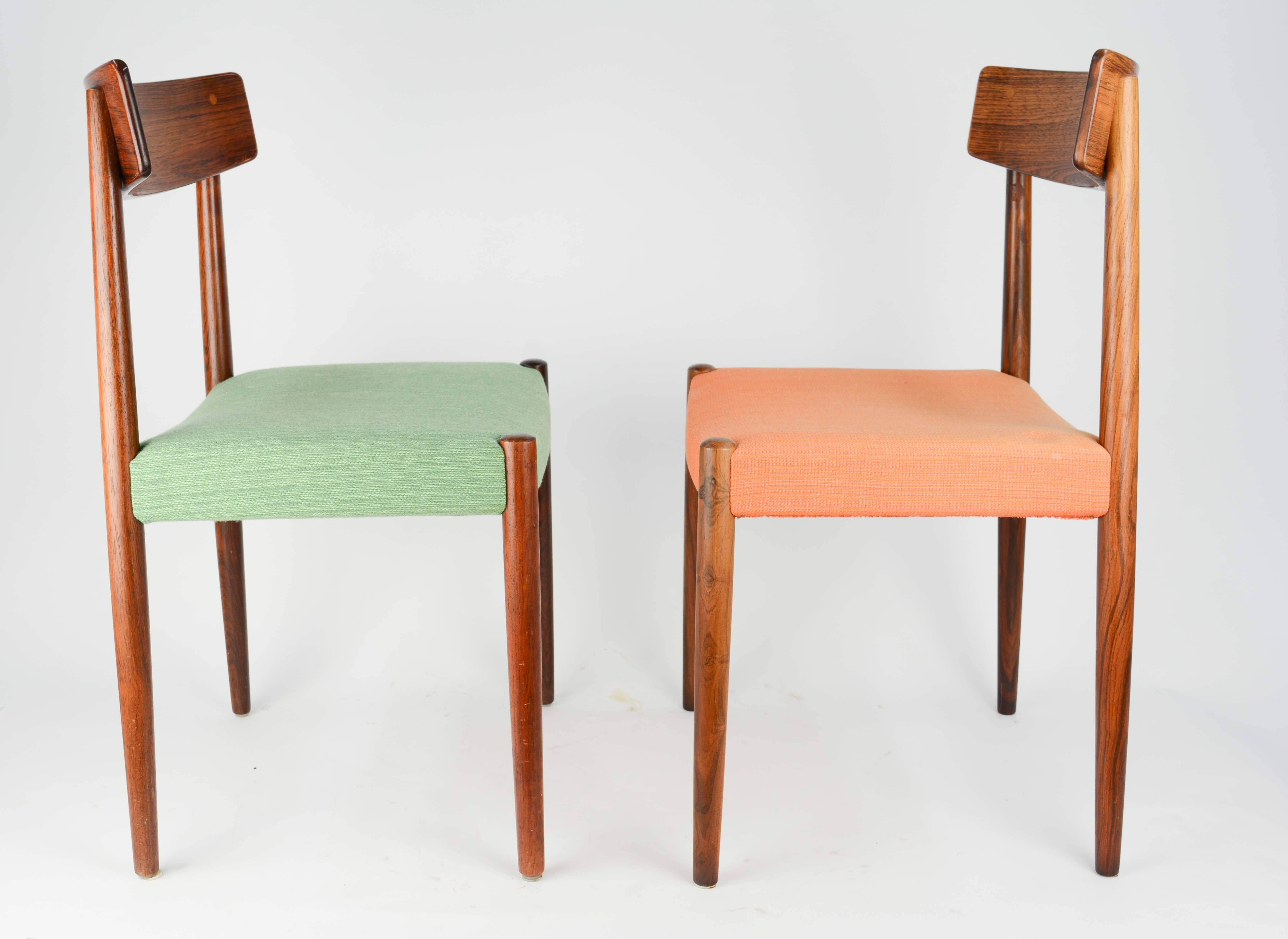 This is a set of eight rosewood chairs by Nils Jonsson for Troeds Bjarnum. There are four green seats and four orange seats.