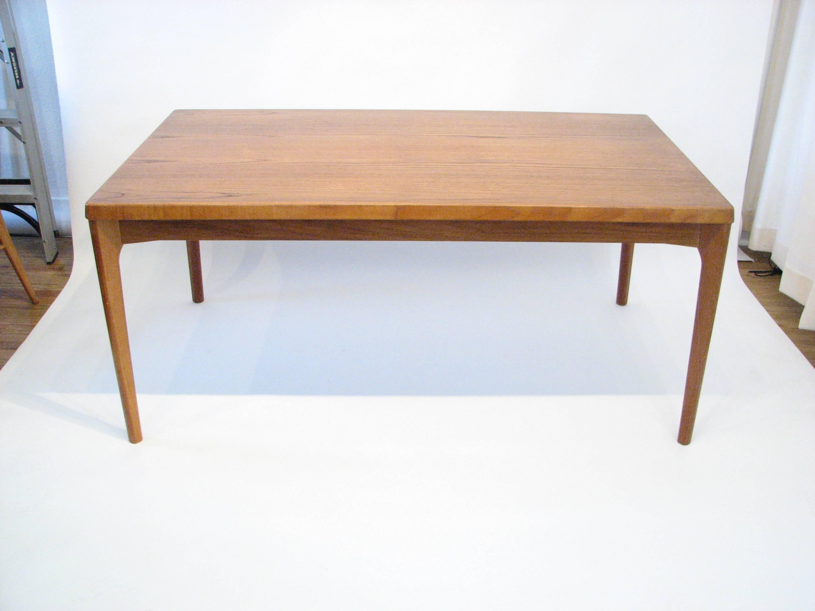 Danish teak dining table with pull-out extension leaves by Henning Kjærnulf for Vejle Stole & Møbelfabrik, 1960s.

Leaves are in pristine condition.  Each leaf adds 21.5 in. in length.

Please Note:  Pickup for this table is in Denver, Colorado.