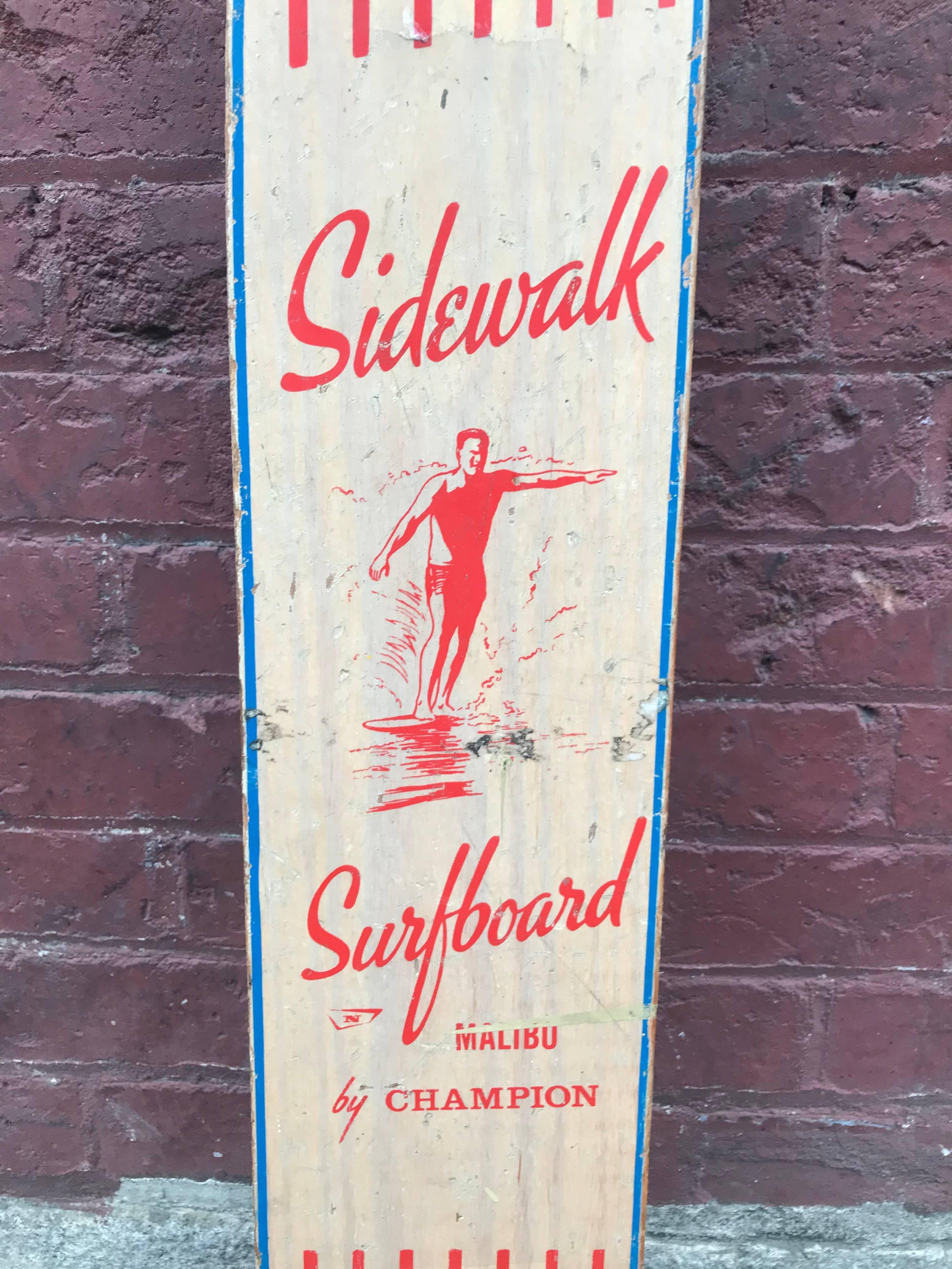 A wonderful example of a skateboard deck by Champion called the Sidewalk Surfboard Malibu with a surf dude hanging 10 on the nose.